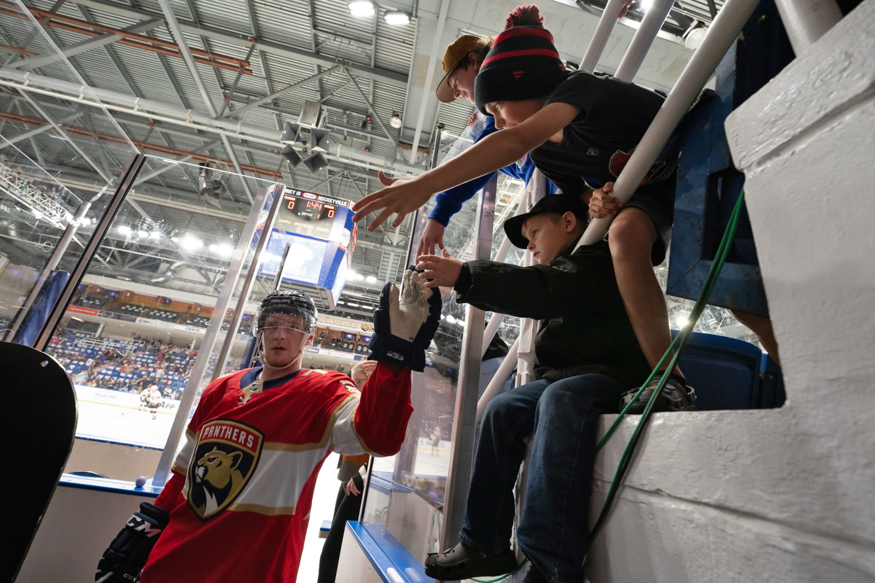 SYDNEY, NOVA SCOTIA - OCTOBER 01: Calle Sjalin #79 of the Florida Panthers high fives a fan after warm-up before the 2022 Kraft Hockeyville game between the Florida Panthers and the Ottawa Senators at Centre 200 on October 01, 2023 in Sydney, Nova Scotia. The Florida Panthers and the Ottawa Senators will play in the 2022 Kraft Hockeyville pre-season game, which was postponed due to the COVID lockdown. (Photo by Steve Wadden/NHLI via Getty Images)