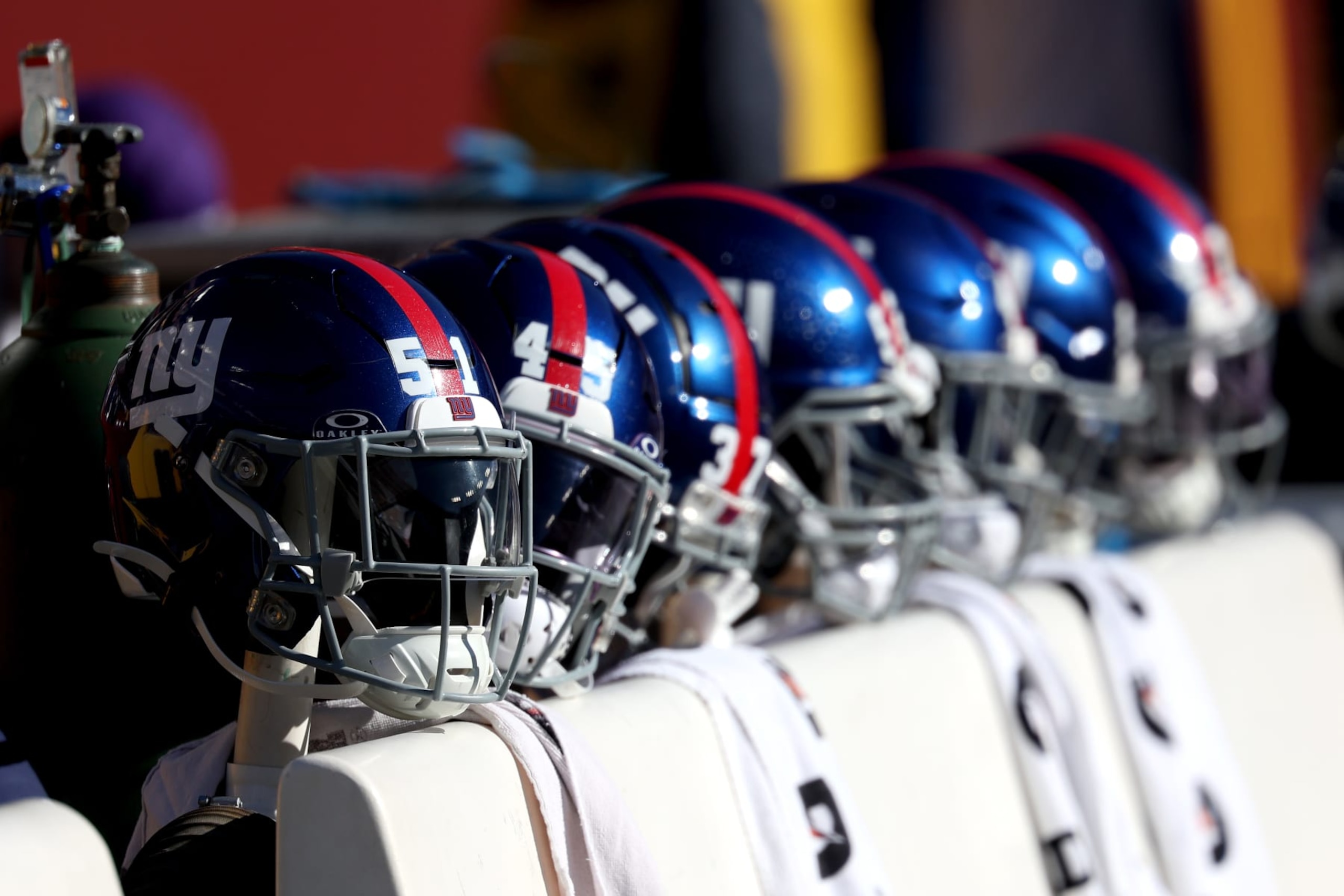 LANDOVER, MARYLAND - NOVEMBER 19: New York Giants helmets sit on the bench before the start of the Giants and Washington Commanders game at FedExField on November 19, 2023 in Landover, Maryland. (Photo by Rob Carr/Getty Images)