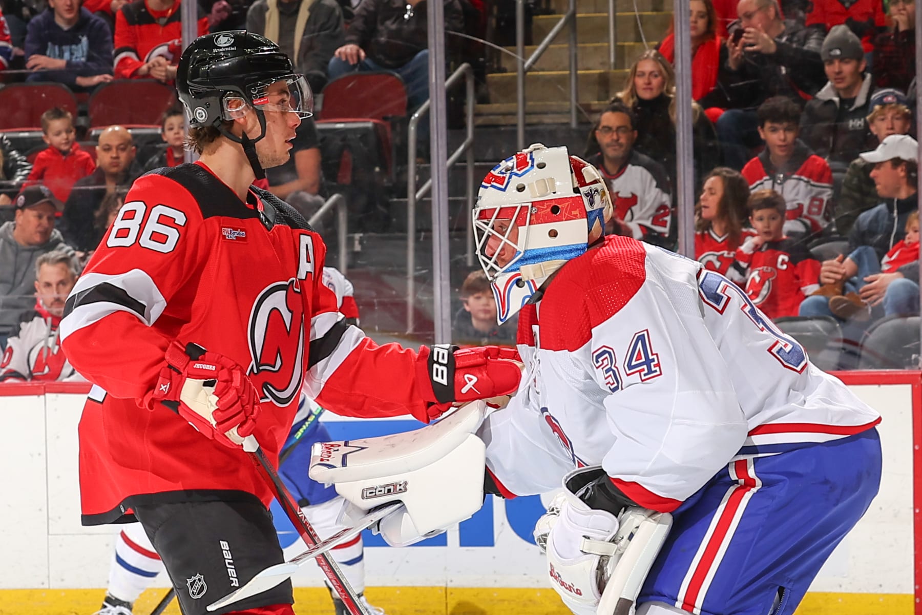 NEWARK, NJ - FEBRUARY 24: Jack Hughes #86 of the New Jersey Devils stands in front of Jake Allen #34 of the Montreal Canadiens during the first period of the game at the Prudential Center on February 24, 2024 in Newark, New Jersey.  (Photo by Rich Graessle/NHLI via Getty Images)