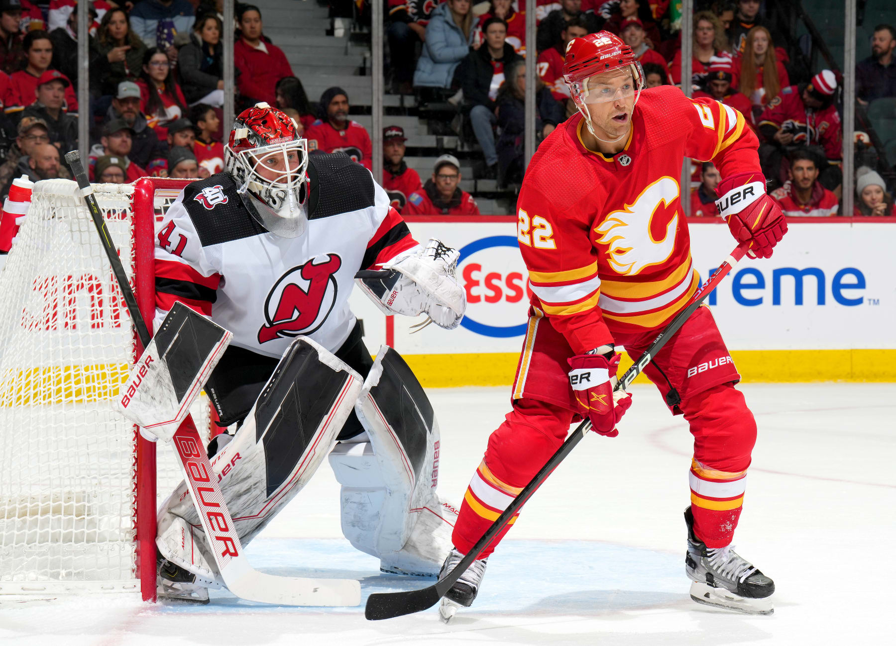 CALGARY, ALBERTA - NOVEMBER 05: Trevor Lewis #22 of the Calgary Flames skates against Vitek Vancek #41 of the New Jersey Devils at Scotiabank Saddledome on November 05, 2022 in Calgary, Alberta. (Photo by Gerry Thomas/NHLI via Getty Images)