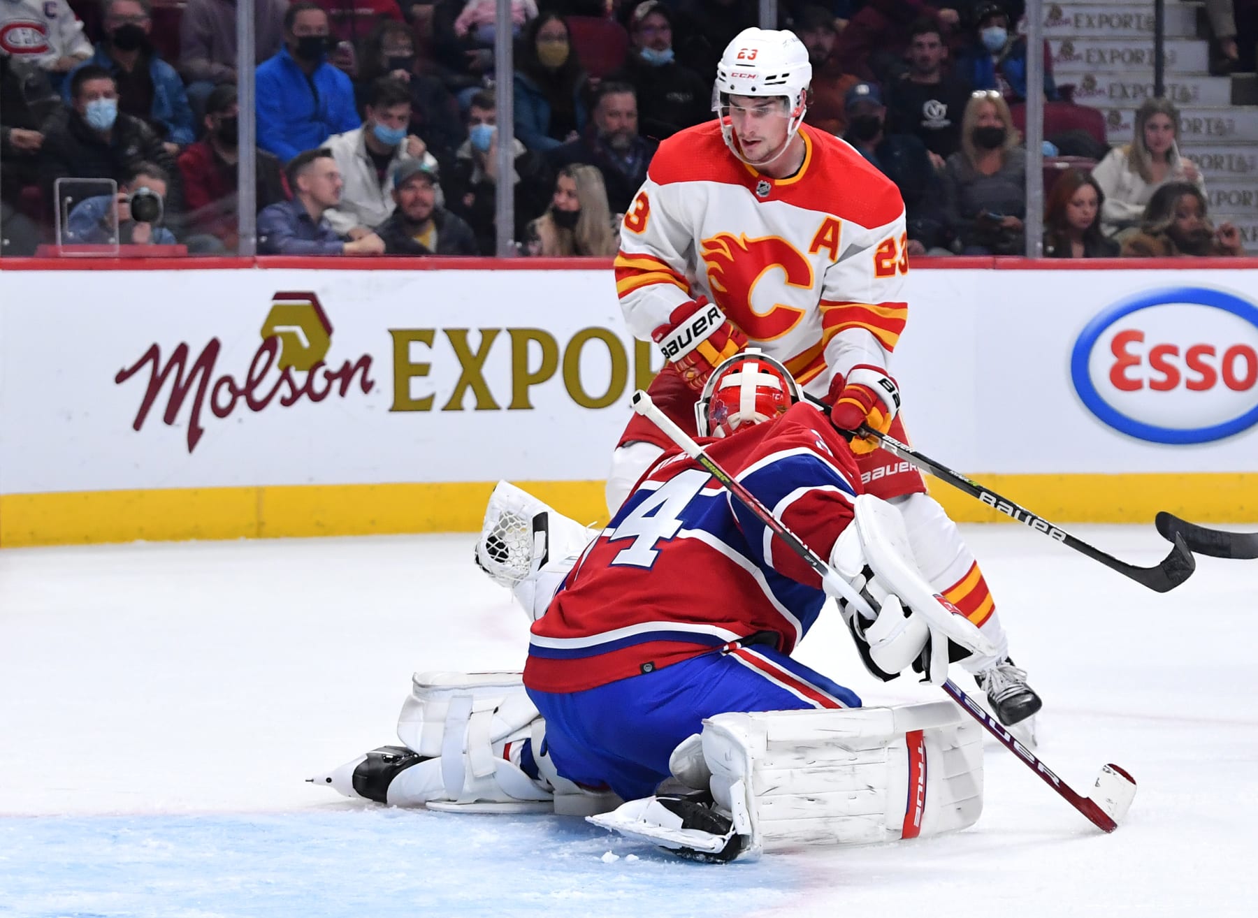 MONTREAL, QC - NOVEMBER 11: Jake Allen #34 of the Montreal Canadiens makes a glove save against Sean Monahan #23 of the Calgary Flames in the NHL game at the Bell Centre on November 11, 2021 in Montreal, Quebec, Canada. (Photo by Francois Lacasse/NHLI via Getty Images)