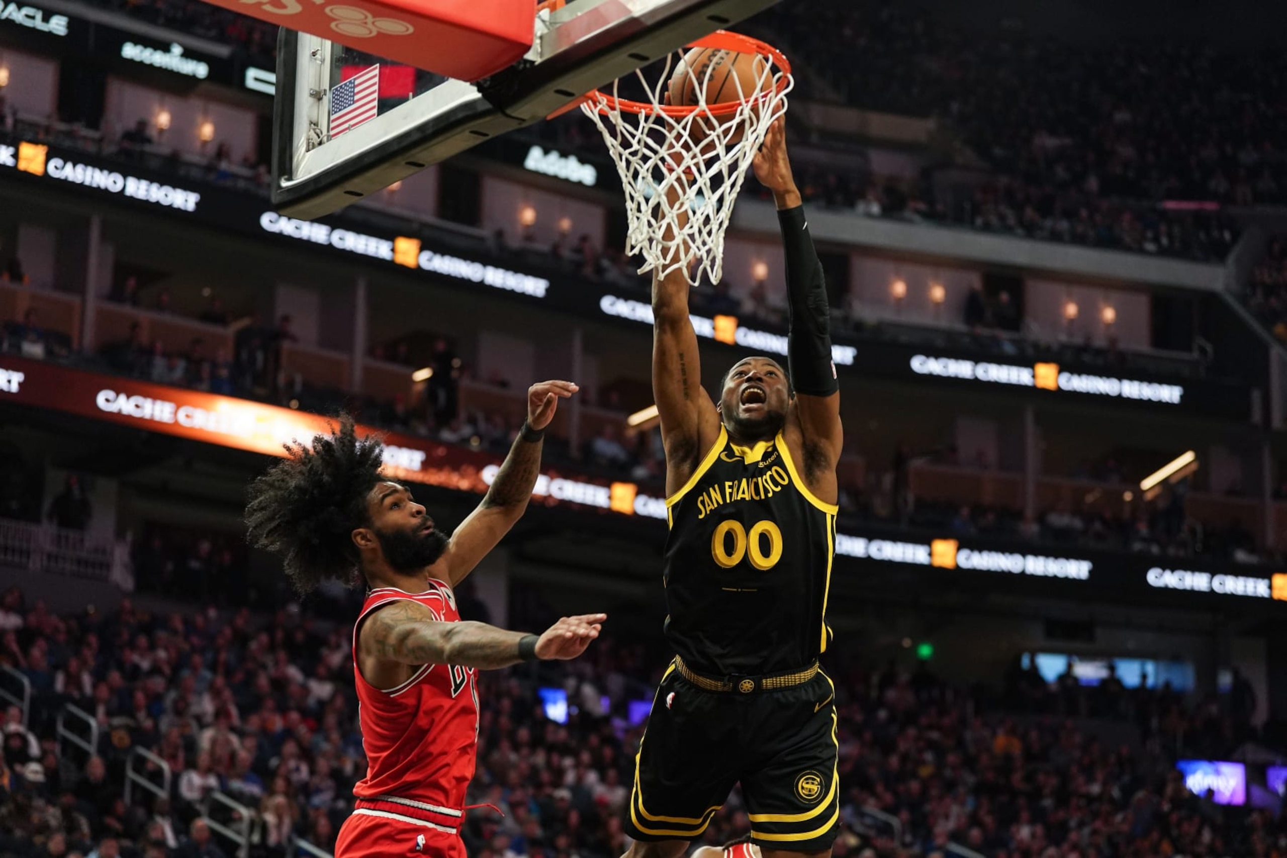 SAN FRANCISCO, CA - MARCH 07: Jonathan Kuminga #00 of the Golden State Warriors goes up for a dunk in the second quarter against Coby White #0 of the Chicago Bulls at Chase Center on March 7, 2024 in San Francisco, California. NOTE TO USER: User expressly acknowledges and agrees that, by downloading and/or using this photograph, User is consenting to the terms and conditions of the Getty Images License Agreement. (Photo by Kavin Mistry/Getty Images)