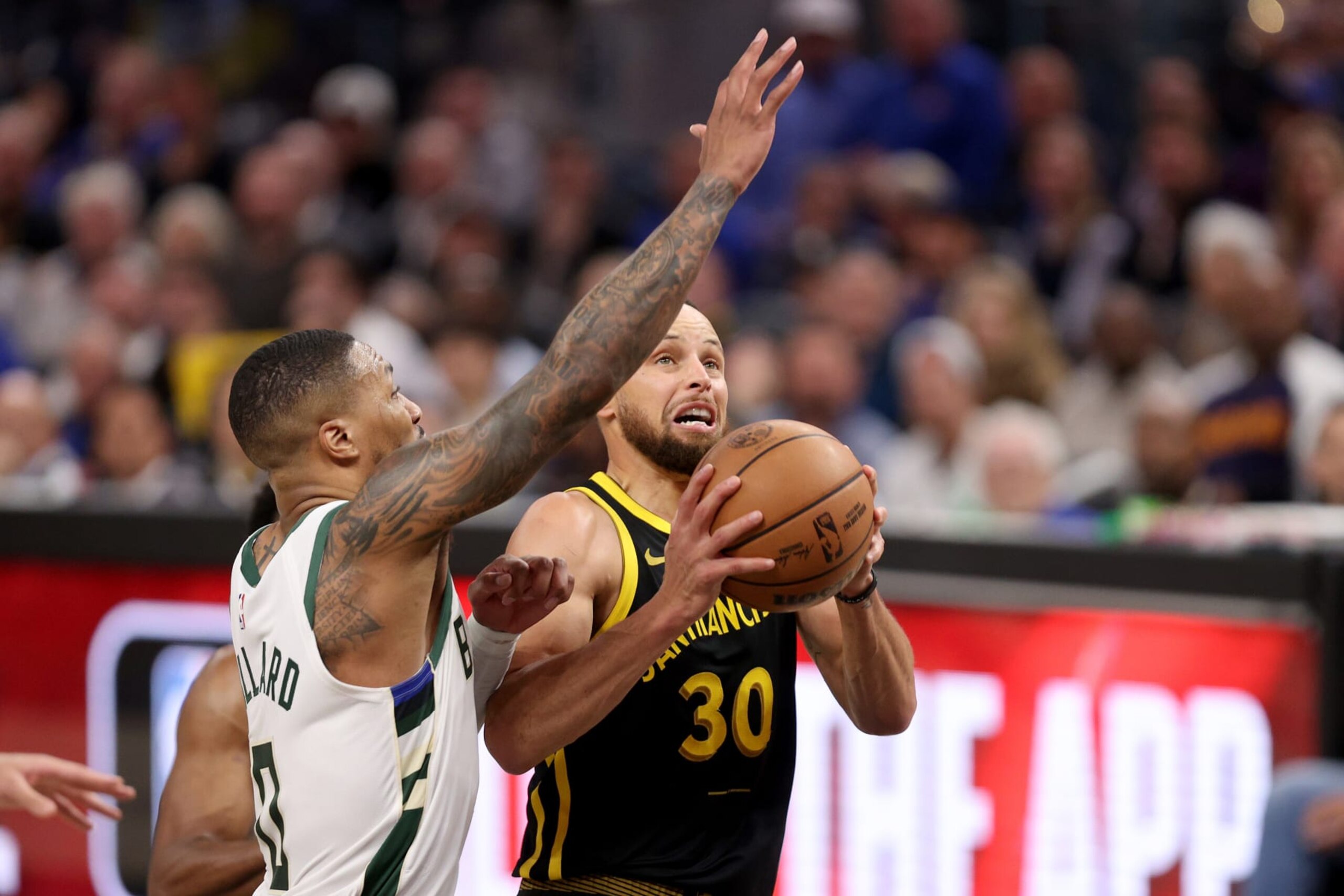 SAN FRANCISCO, CALIFORNIA - MARCH 06: Stephen Curry #30 of the Golden State Warriors goes up for a shot on Damian Lillard #0 of the Milwaukee Bucks in the second half at Chase Center on March 06, 2024 in San Francisco, California. NOTE TO USER: User expressly acknowledges and agrees that, by downloading and or using this photograph, User is consenting to the terms and conditions of the Getty Images License Agreement.  (Photo by Ezra Shaw/Getty Images)