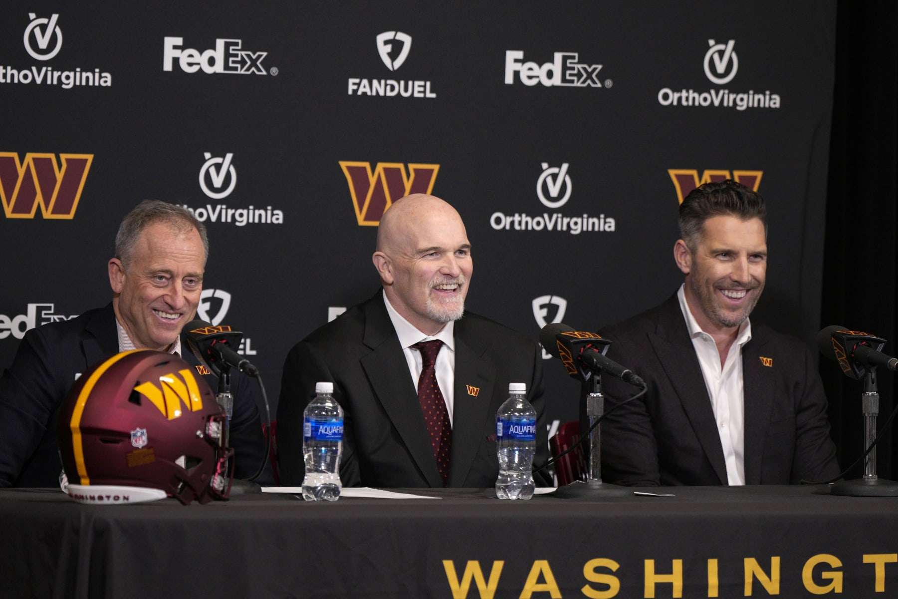ASHBURN, VIRGINIA - FEBRUARY 05: Head coach Dan Quinn of the Washington Commanders speaks during a press conference alongside managing partner Josh Harris, left, and general manager Adam Peters at OrthoVirginia Training Center at Commanders Park on February 05, 2024 in Ashburn, Virginia. (Photo by Jess Rapfogel/Getty Images)