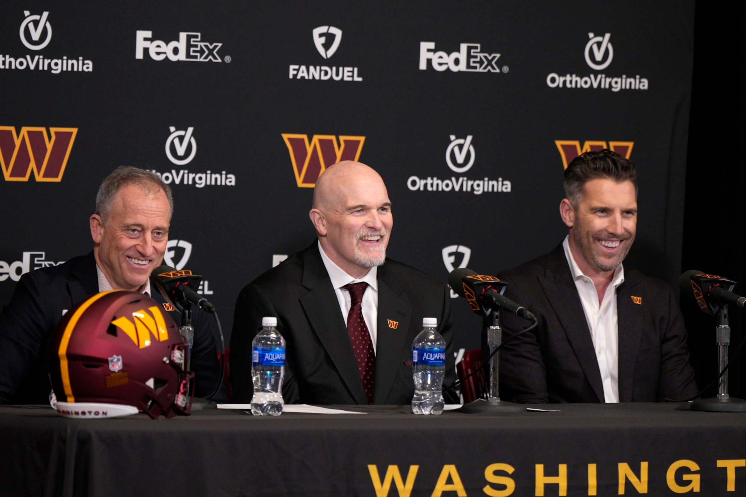 ASHBURN, VIRGINIA - FEBRUARY 05: Head coach Dan Quinn of the Washington Commanders speaks during a press conference alongside managing partner Josh Harris, left, and general manager Adam Peters at OrthoVirginia Training Center at Commanders Park on February 05, 2024 in Ashburn, Virginia. (Photo by Jess Rapfogel/Getty Images)