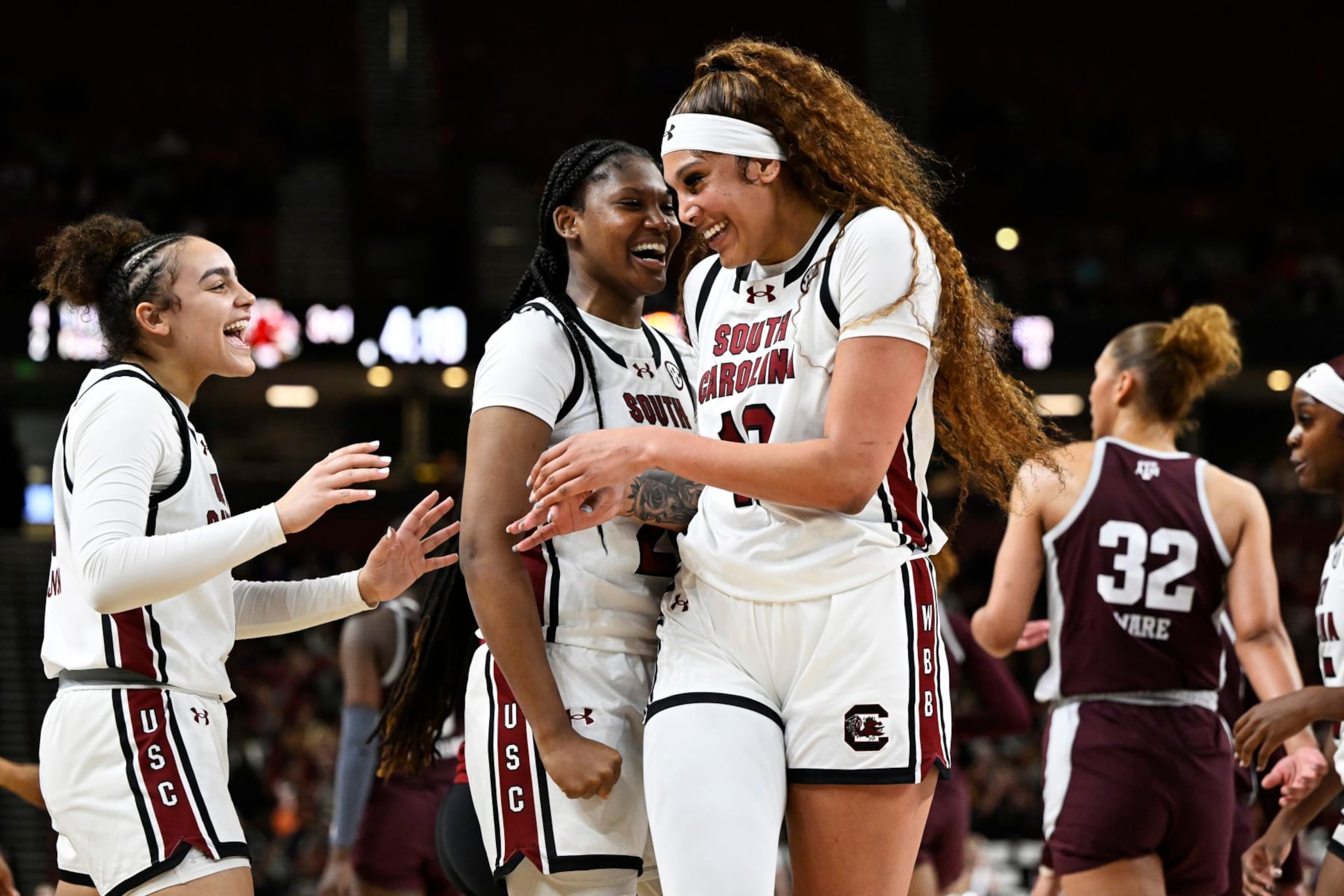 GREENVILLE, SOUTH CAROLINA - MARCH 08: Kamilla Cardoso #10, Sania Feagin #20, and Tessa Johnson #5 of the South Carolina Gamecocks celebrate against the Texas A&M Aggies in the third quarter during the quarterfinals of the SEC Women's Basketball Tournament at Bon Secours Wellness Arena on March 08, 2024 in Greenville, South Carolina. (Photo by Eakin Howard/Getty Images)