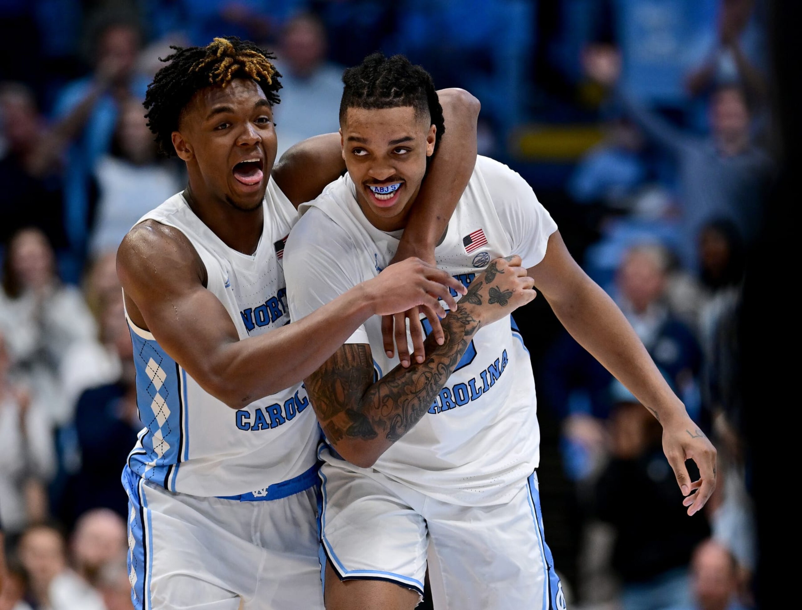 CHAPEL HILL, NORTH CAROLINA - MARCH 05: Harrison Ingram #55 celebrates with Armando Bacot #5 of the North Carolina Tar Heels after Bacot's second three-point basket during the second half of the game against the Notre Dame Fighting Irish at the Dean E. Smith Center on March 05, 2024 in Chapel Hill, North Carolina. The Tar Heels won 84-51. (Photo by Grant Halverson/Getty Images)