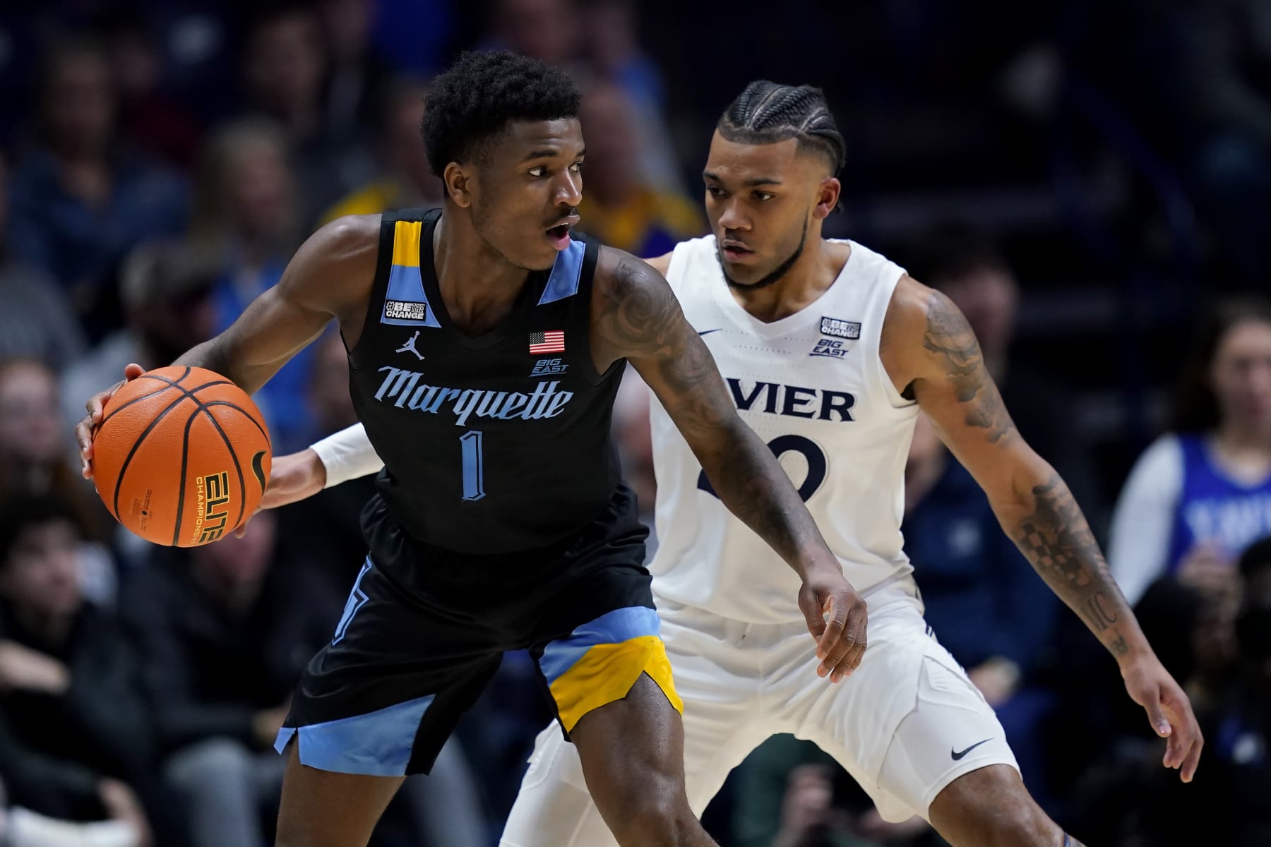 CINCINNATI, OHIO - MARCH 09: Kam Jones #1 of the Marquette Golden Eagles dribbles the ball while being guarded by Dayvion McKnight #20 of the Xavier Musketeers in the first half at the Cintas Center on March 09, 2024 in Cincinnati, Ohio. (Photo by Dylan Buell/Getty Images)