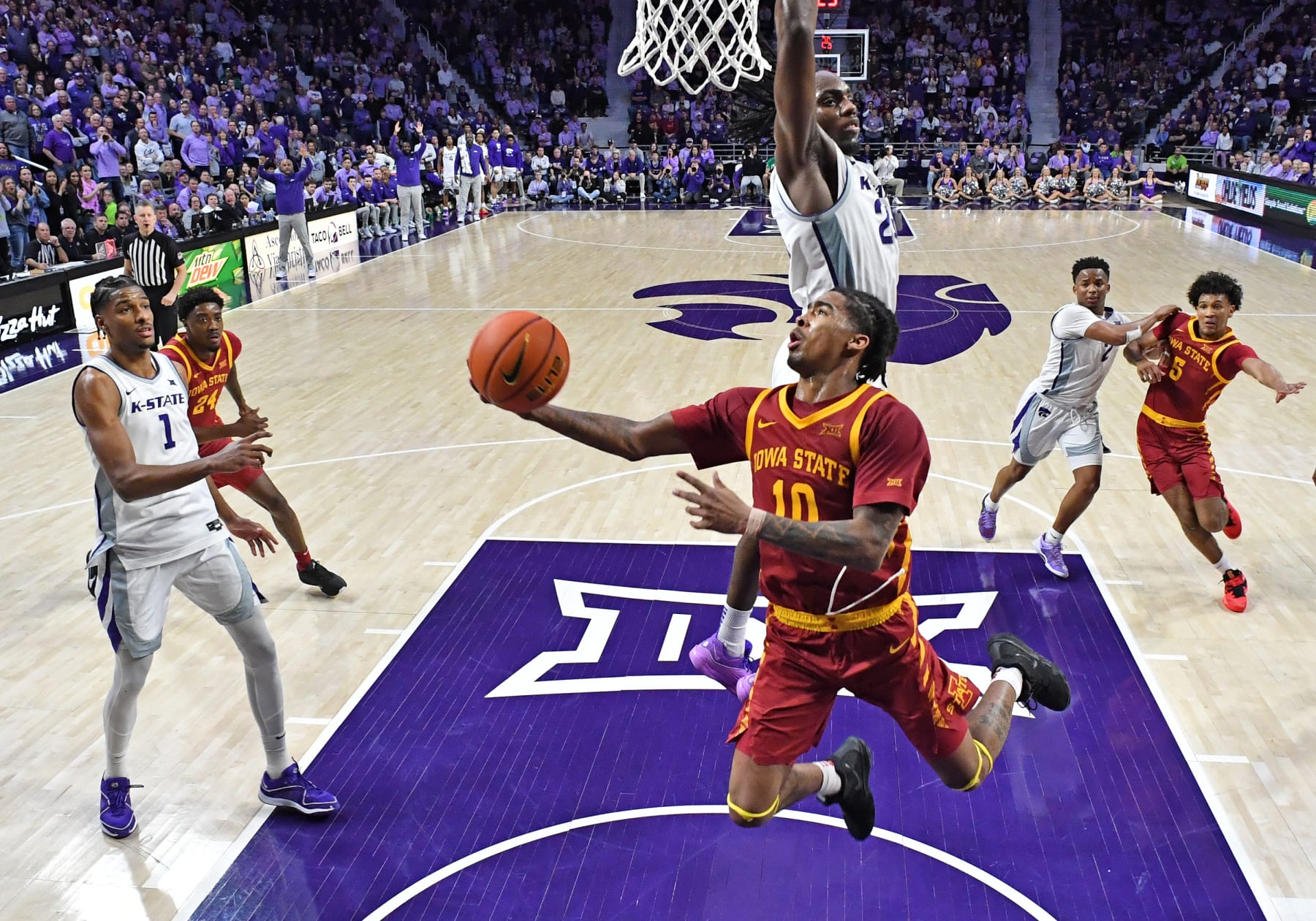 MANHATTAN, KS - MARCH 09:  Keshon Gilbert #10 of the Iowa State Cyclones drives to the basket against Arthur Kaluma #24 of the Kansas State Wildcats in the second half at Bramlage Coliseum on March 9, 2024 in Manhattan, Kansas.  (Photo by Peter Aiken/Getty Images)