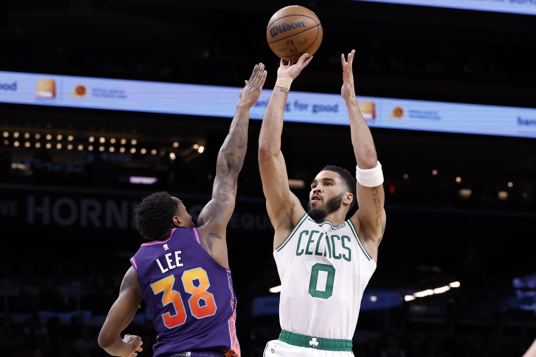 PHOENIX, ARIZONA - MARCH 09: Jayson Tatum #0 of the Boston Celtics attempts a shot over Saben Lee #38 of the Phoenix Suns during the first half at Footprint Center on March 09, 2024 in Phoenix, Arizona. NOTE TO USER: User expressly acknowledges and agrees that, by downloading and or using this photograph, User is consenting to the terms and conditions of the Getty Images License Agreement.  (Photo by Chris Coduto/Getty Images)