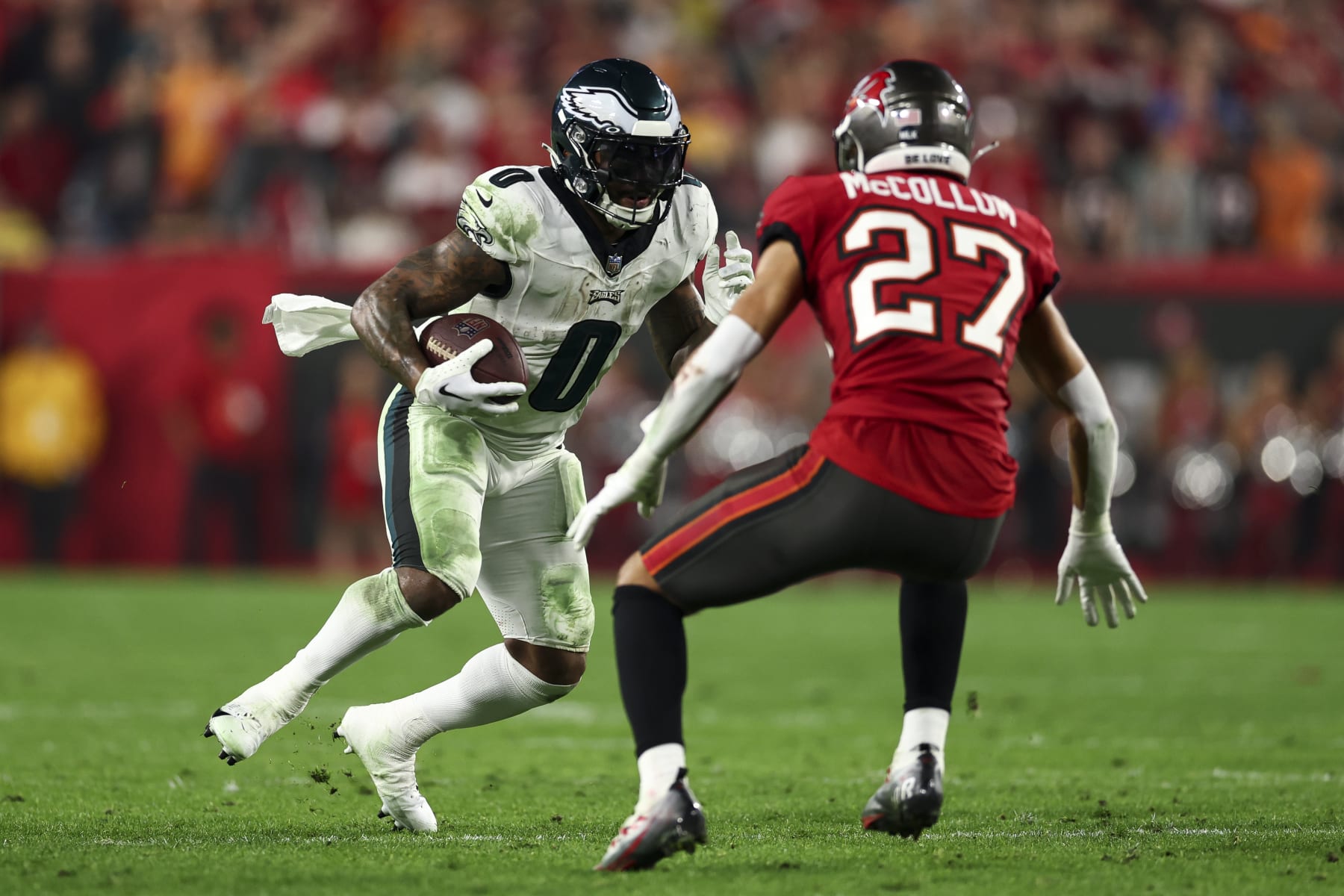 TAMPA, FL - JANUARY 15: D'Andre Swift #0 of the Philadelphia Eagles carries the ball as Zyon McCollum #27 of the Tampa Bay Buccaneers defends during an NFL wild-card playoff football game at Raymond James Stadium on January 15, 2024 in Tampa, Florida. (Photo by Kevin Sabitus/Getty Images)