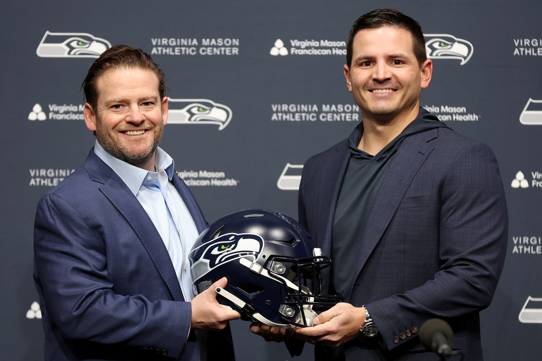 RENTON, WASHINGTON - FEBRUARY 01: John Schneider, general manager of the Seattle Seahawks, poses with Mike Macdonald as Macdonald is announced as the new Seattle Seahawks head coach at Virginia Mason Athletic Center on February 01, 2024 in Renton, Washington. (Photo by Steph Chambers/Getty Images)