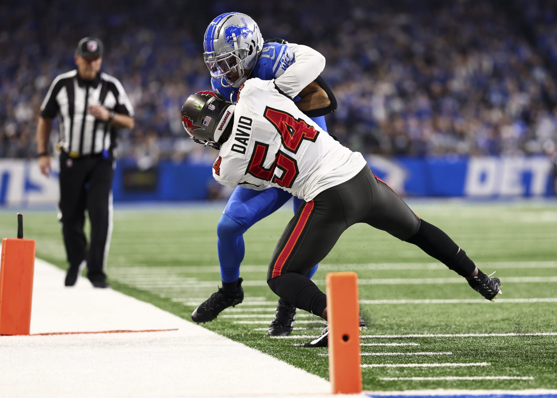 DETROIT, MI - JANUARY 21: Lavonte David #54 of the Tampa Bay Buccaneers tackles Amon-Ra St. Brown #14 of the Detroit Lions during the third quarter of an NFL divisional round playoff football game at Ford Field on January 21, 2024 in Detroit, Michigan. (Photo by Kevin Sabitus/Getty Images)