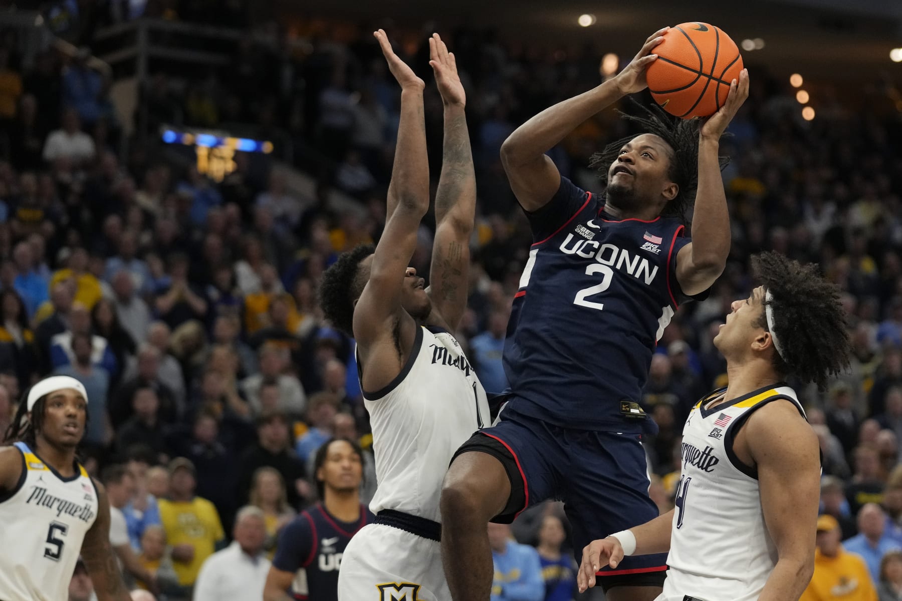 MILWAUKEE, WISCONSIN - MARCH 06: Tristen Newton #2 of the Connecticut Huskies goes up for a shot against Kam Jones #1 of the Marquette Golden Eagles during the second half at Fiserv Forum on March 06, 2024 in Milwaukee, Wisconsin. (Photo by Patrick McDermott/Getty Images)