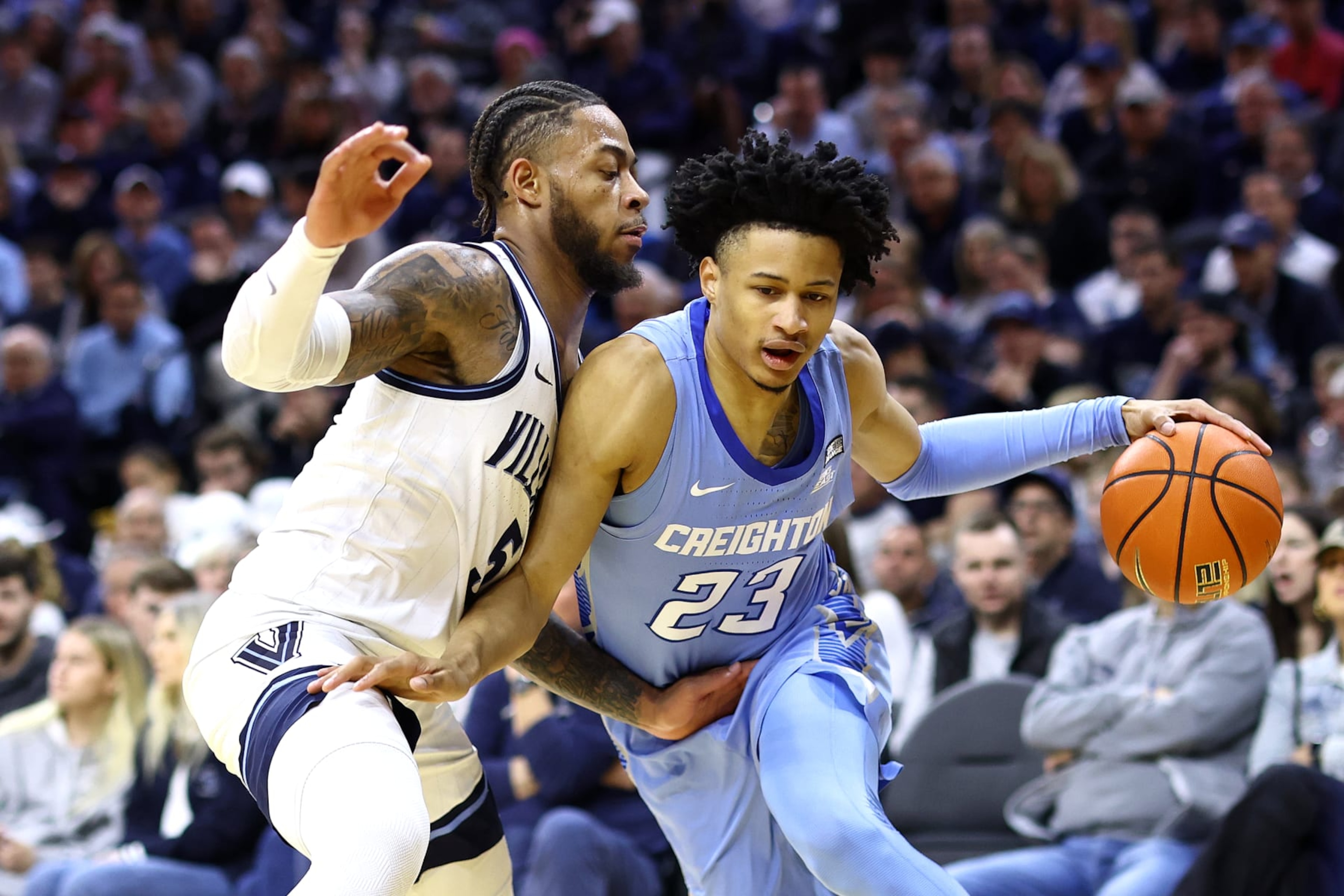 PHILADELPHIA, PENNSYLVANIA - MARCH 09: Trey Alexander #23 of the Creighton Bluejays dribbles by Justin Moore #5 of the Villanova Wildcats during the first half at the Wells Fargo Center on March 09, 2024 in Philadelphia, Pennsylvania. (Photo by Tim Nwachukwu/Getty Images) PHILADELPHIA, PENNSYLVANIA - MARCH 09: Trey Alexander #23 of the Creighton Bluejays dribbles by Justin Moore #5 of the Villanova Wildcats during the first half at the Wells Fargo Center on March 09, 2024 in Philadelphia, Pennsylvania. (Photo by Tim Nwachukwu/Getty Images)