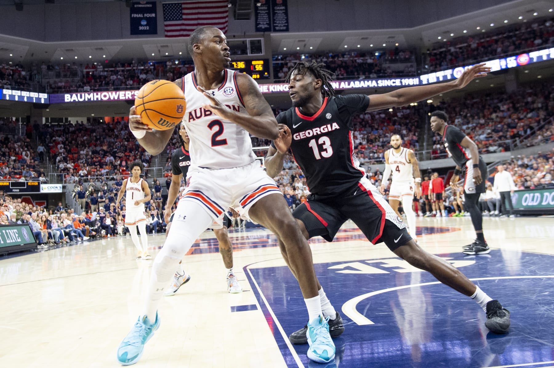 AUBURN, ALABAMA - MARCH 09: Jaylin Williams #2 of the Auburn Tigers looks to maneuver the ball by Dylan James #13 of the Georgia Bulldogs during the second half of play at Neville Arena on March 09, 2024 in Auburn, Alabama. (Photo by Michael Chang/Getty Images)