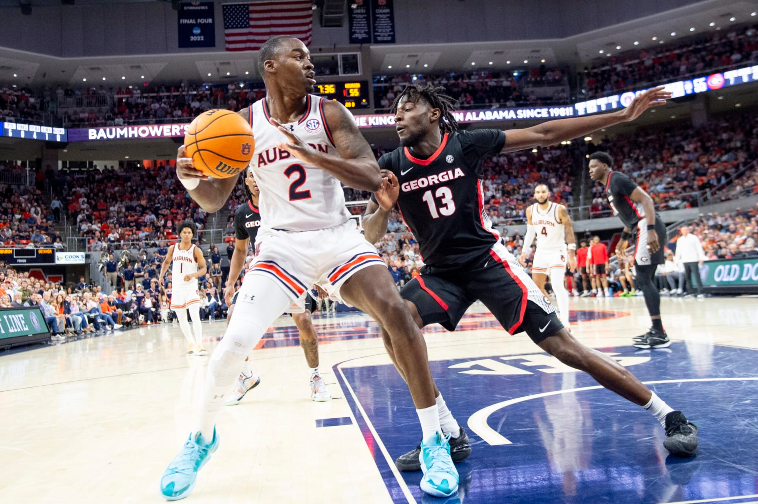 AUBURN, ALABAMA - MARCH 09: Jaylin Williams #2 of the Auburn Tigers looks to maneuver the ball by Dylan James #13 of the Georgia Bulldogs during the second half of play at Neville Arena on March 09, 2024 in Auburn, Alabama. (Photo by Michael Chang/Getty Images)