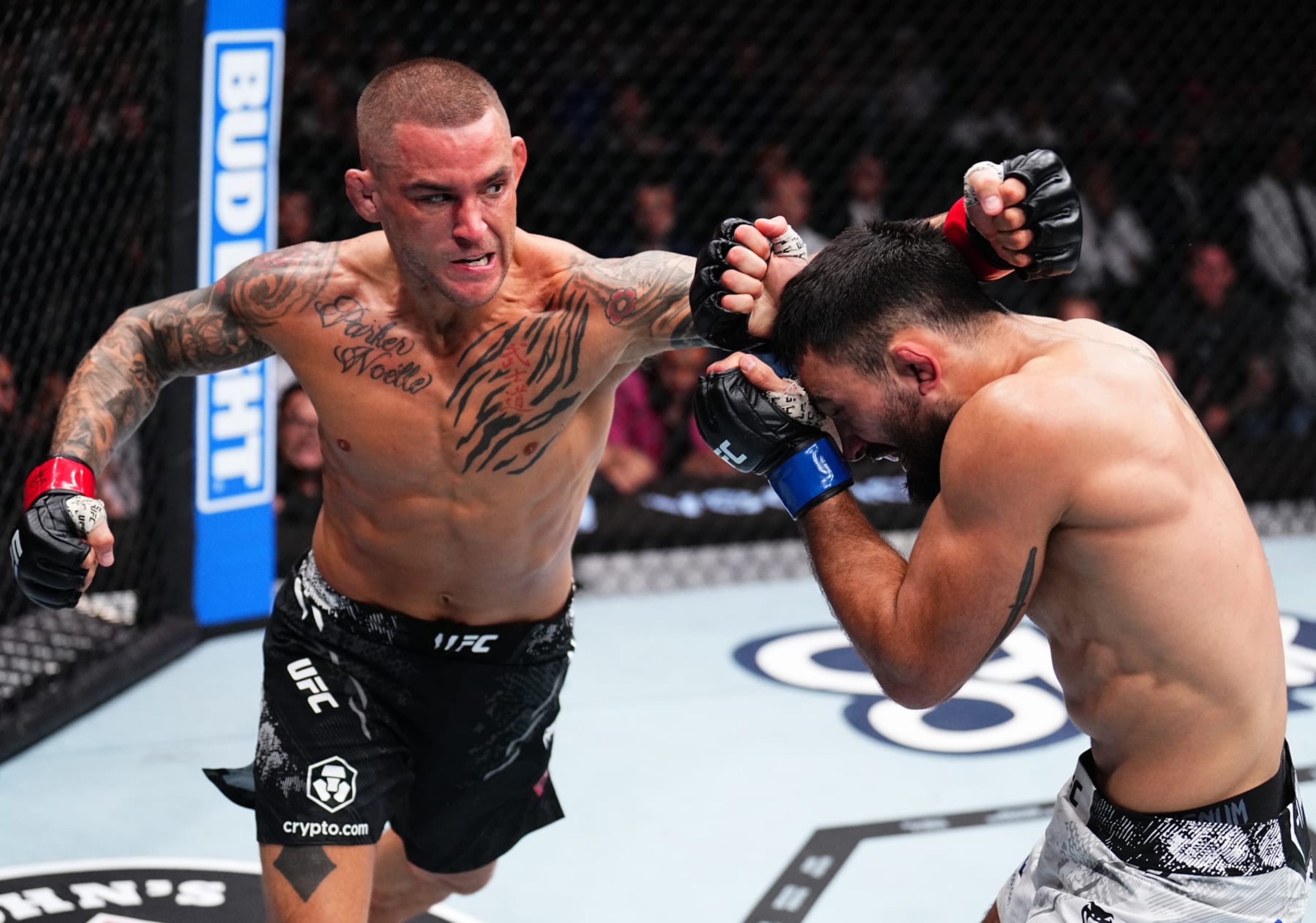 MIAMI, FLORIDA - MARCH 09: (L-R) Dustin Poirier punches Benoit Saint Denis of France in a lightweight fight during the UFC 299 event at Kaseya Center on March 09, 2024 in Miami, Florida. (Photo by Chris Unger/Zuffa LLC via Getty Images)