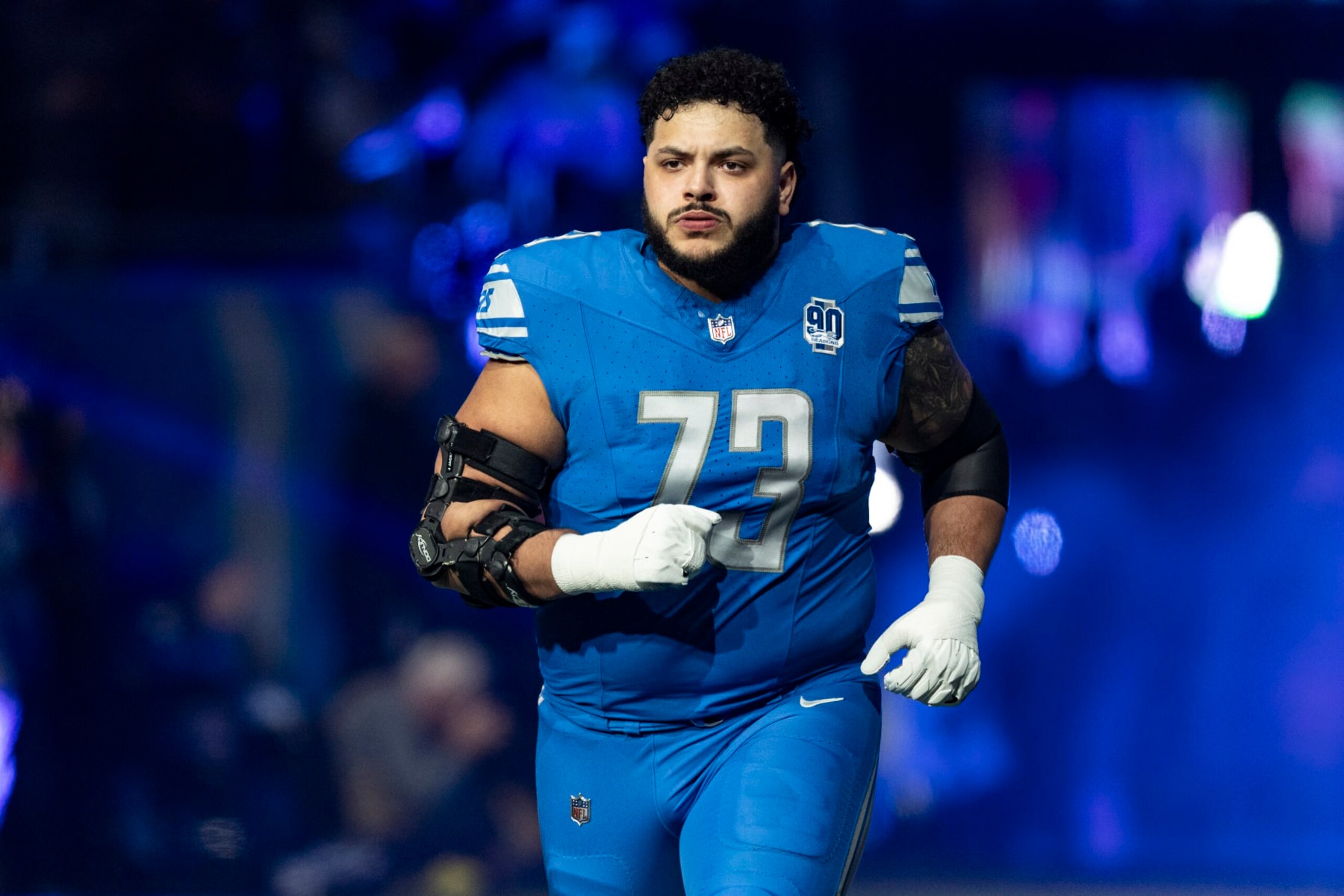 DETROIT, MICHIGAN - JANUARY 14: Jonah Jackson #73 of the Detroit Lions runs onto the field before the game against the Los Angeles Rams at Ford Field on January 14, 2024 in Detroit, Michigan. The Lions beat the Rams 24-23. (Photo by Lauren Leigh Bacho/Getty Images)