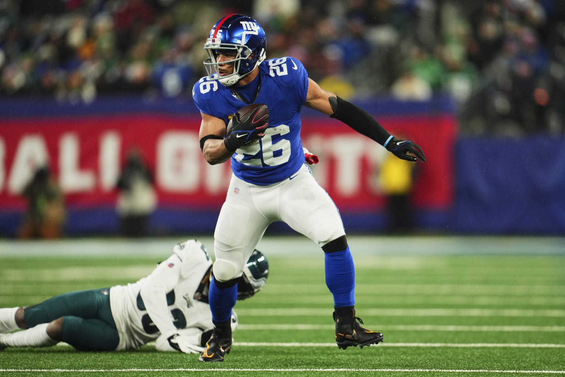 EAST RUTHERFORD, NJ - JANUARY 07: Saquon Barkley #26 of the New York Giants runs with the ball against the Philadelphia Eagles during the first half at MetLife Stadium on January 7, 2024 in East Rutherford, New Jersey. (Photo by Cooper Neill/Getty Images)