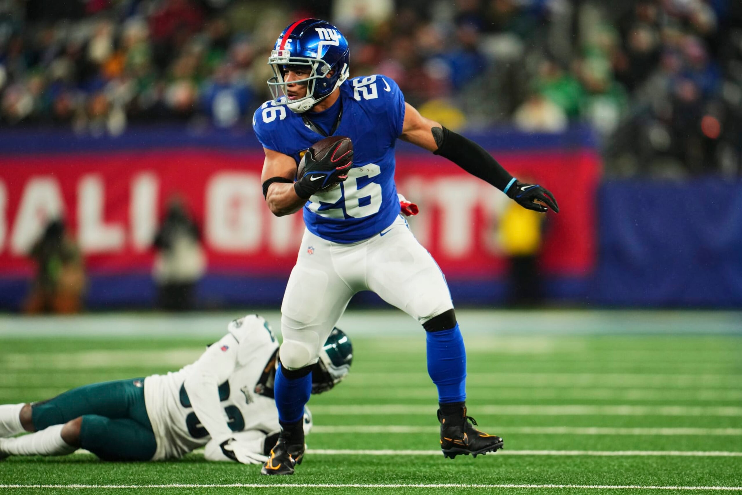 EAST RUTHERFORD, NJ - JANUARY 07: Saquon Barkley #26 of the New York Giants runs with the ball against the Philadelphia Eagles during the first half at MetLife Stadium on January 7, 2024 in East Rutherford, New Jersey. (Photo by Cooper Neill/Getty Images)