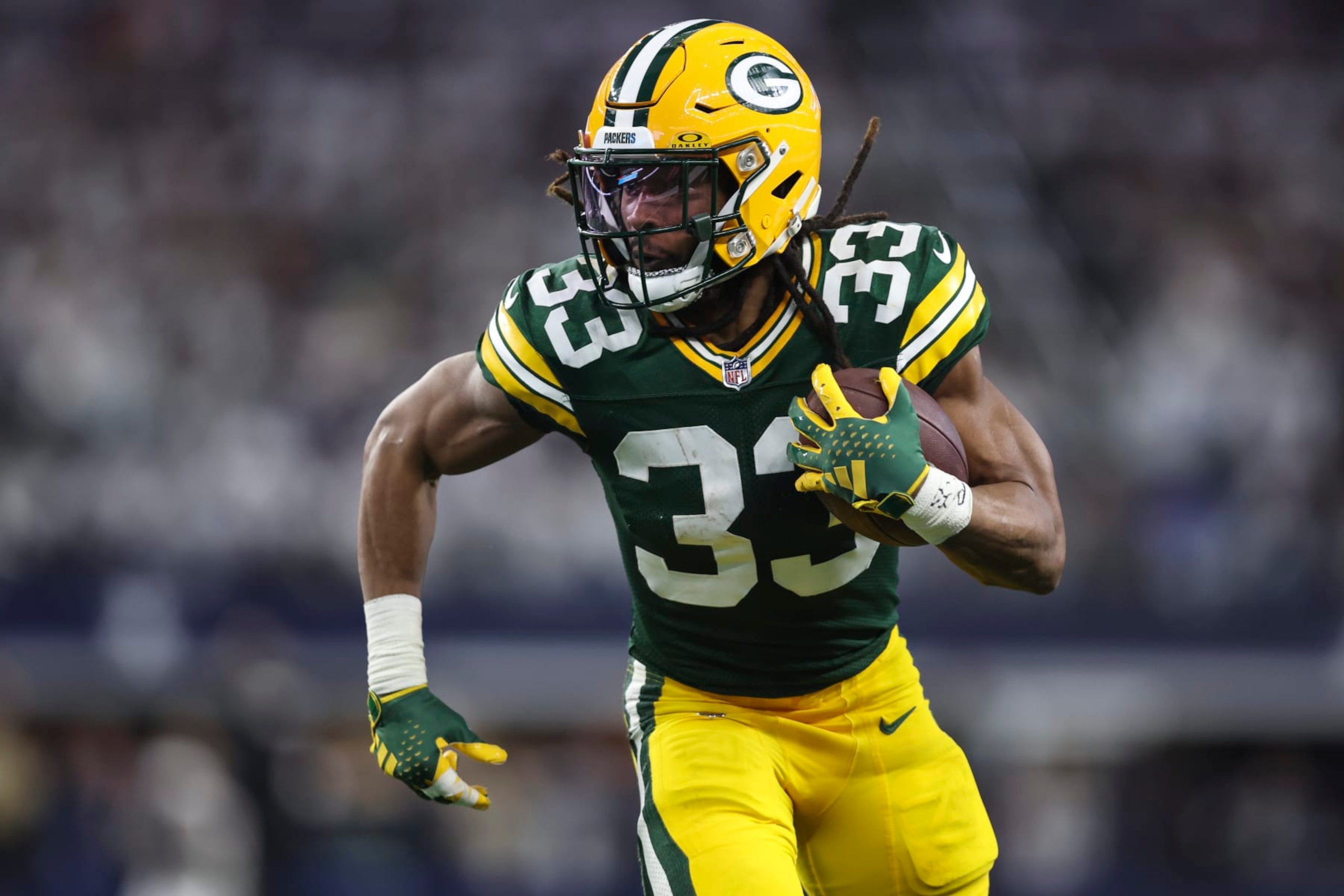ARLINGTON, TX - JANUARY 14: Aaron Jones #33 of the Green Bay Packers runs the ball during an NFL wild-card playoff football game against the Dallas Cowboys at AT&T Stadium on January 14, 2024 in Arlington, Texas. (Photo by Perry Knotts/Getty Images)
