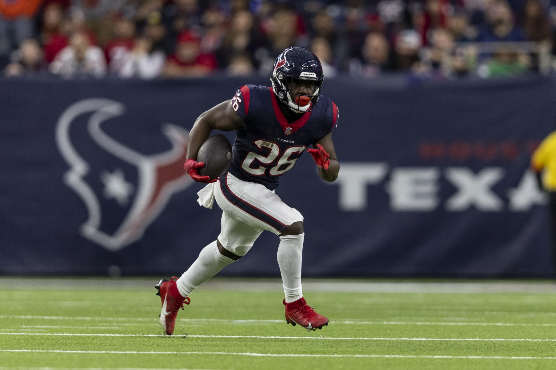 HOUSTON, TEXAS - JANUARY 13: Devin Singletary #26 of the Houston Texans runs with the ball against Greg Newsome II #0 of the Cleveland Browns during an NFL wild-card playoff football game between the Houston Texans and the Cleveland Browns at NRG Stadium on January 13, 2024 in Houston, Texas. (Photo by Michael Owens/Getty Images)