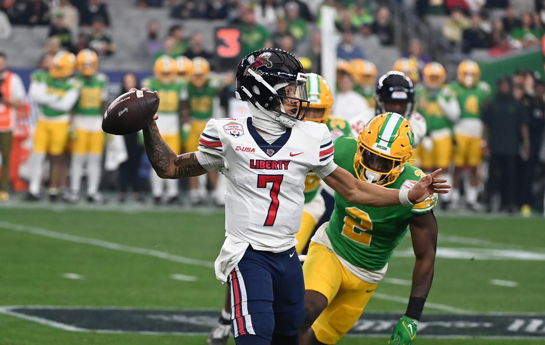 GLENDALE, ARIZONA - JANUARY 01: Kaidon Salter #7 of the Liberty Flames throws the ball against the Oregon Ducks during the second quarter of the 2023 Vrbo Fiesta Bowl game at State Farm Stadium on January 01, 2024 in Glendale, Arizona. (Photo by Norm Hall/Getty Images)
