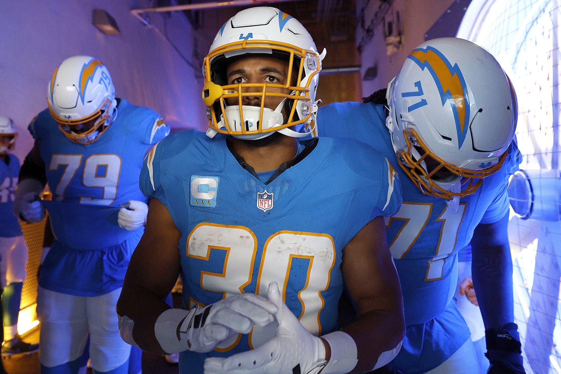 INGLEWOOD, CALIFORNIA - JANUARY 07: Trey Pipkins III #79, Austin Ekeler #30 and Jordan McFadden #71 of the Los Angeles Charger prepare in the tunnel before a game against the Kansas City Chiefs at SoFi Stadium on January 07, 2024 in Inglewood, California. (Photo by Kevork Djansezian/Getty Images)