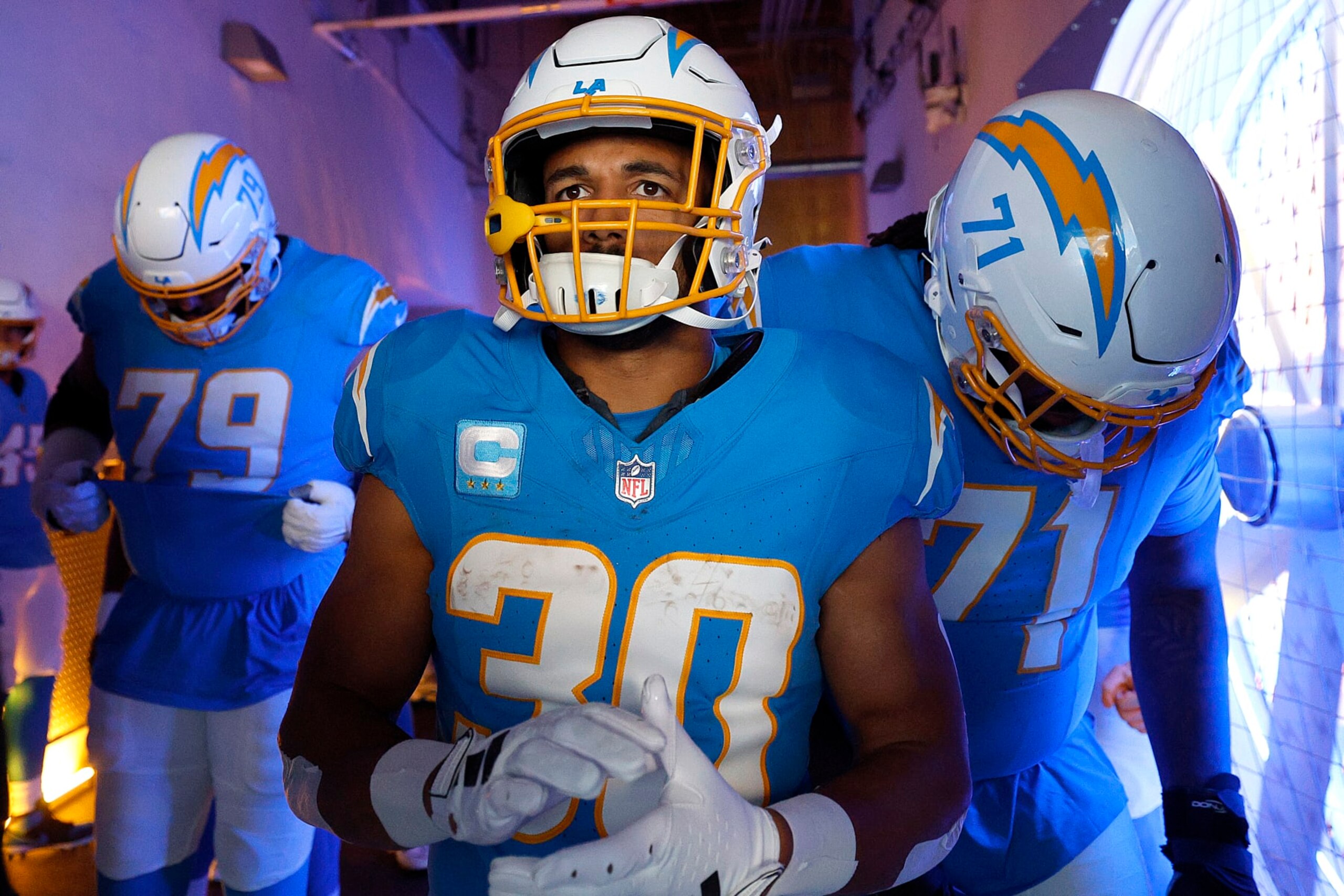 INGLEWOOD, CALIFORNIA - JANUARY 07: Trey Pipkins III #79, Austin Ekeler #30 and Jordan McFadden #71 of the Los Angeles Charger prepare in the tunnel before a game against the Kansas City Chiefs at SoFi Stadium on January 07, 2024 in Inglewood, California. (Photo by Kevork Djansezian/Getty Images)