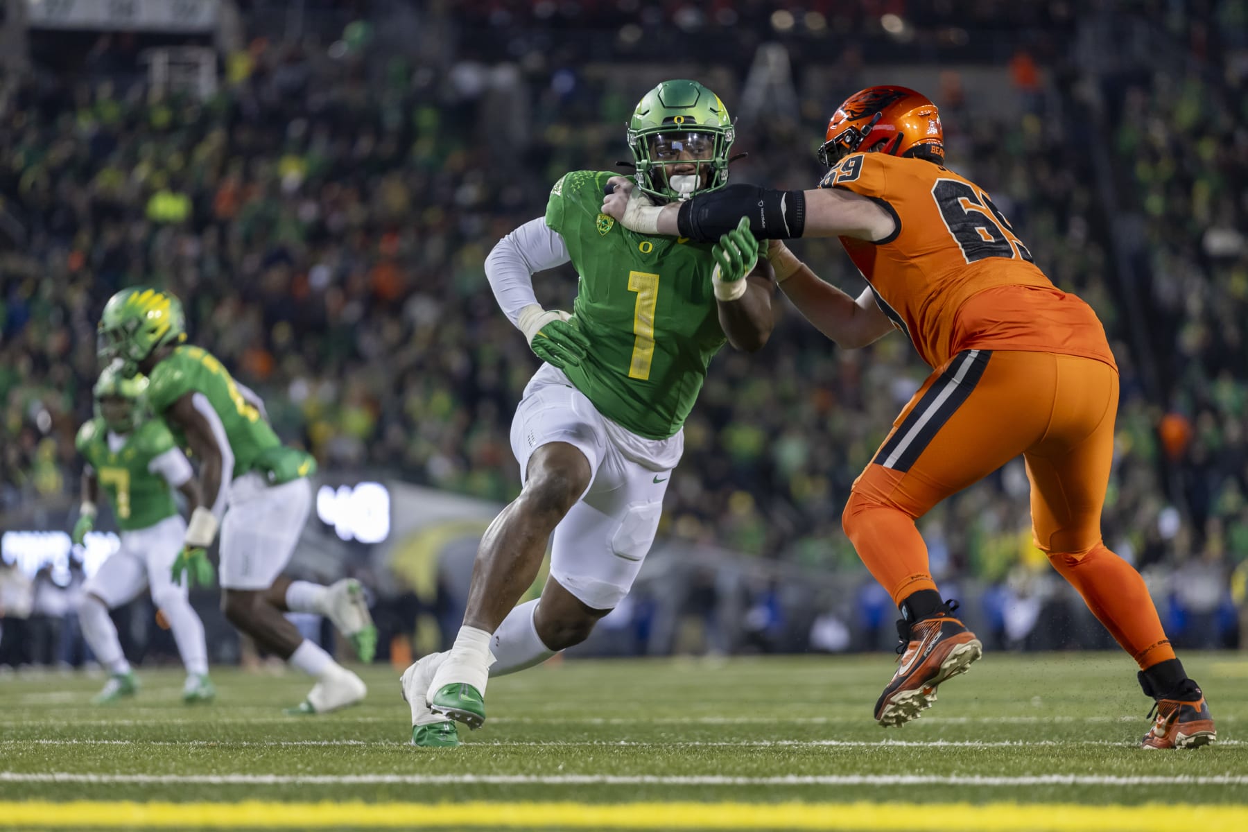 EUGENE, OREGON - NOVEMBER 24: Defensive end Jordan Burch #1 of the Oregon Ducks runs on the field against the Oregon State Beavers at Autzen Stadium on November 24, 2023 in Eugene, Oregon. (Photo by Tom Hauck/Getty Images)