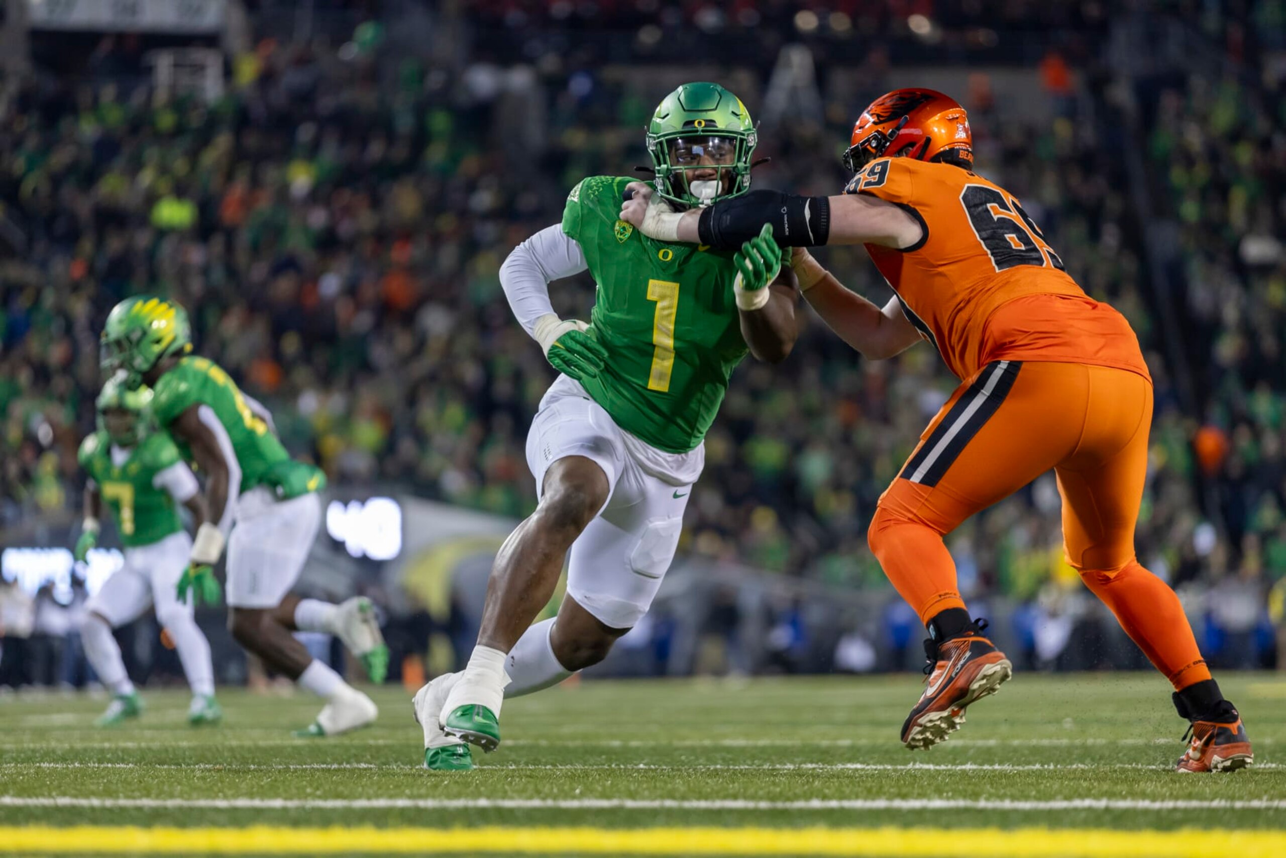 EUGENE, OREGON - NOVEMBER 24: Defensive end Jordan Burch #1 of the Oregon Ducks runs on the field against the Oregon State Beavers at Autzen Stadium on November 24, 2023 in Eugene, Oregon. (Photo by Tom Hauck/Getty Images)