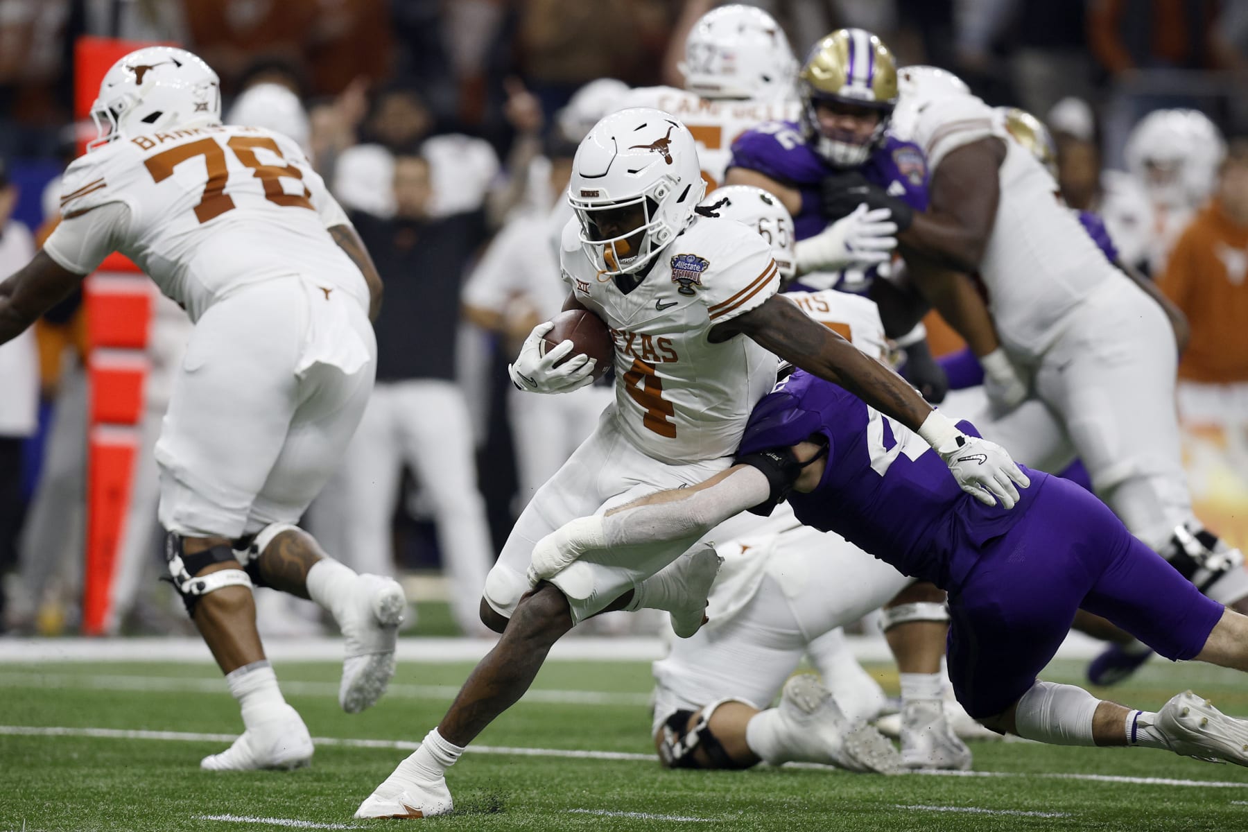 NEW ORLEANS, LOUISIANA - JANUARY 01: CJ Baxter #4 of the Texas Longhorns carries the ball during the first quarter against the Washington Huskies during the CFP Semifinal Allstate Sugar Bowl at Caesars Superdome on January 01, 2024 in New Orleans, Louisiana. (Photo by Sean Gardner/Getty Images)