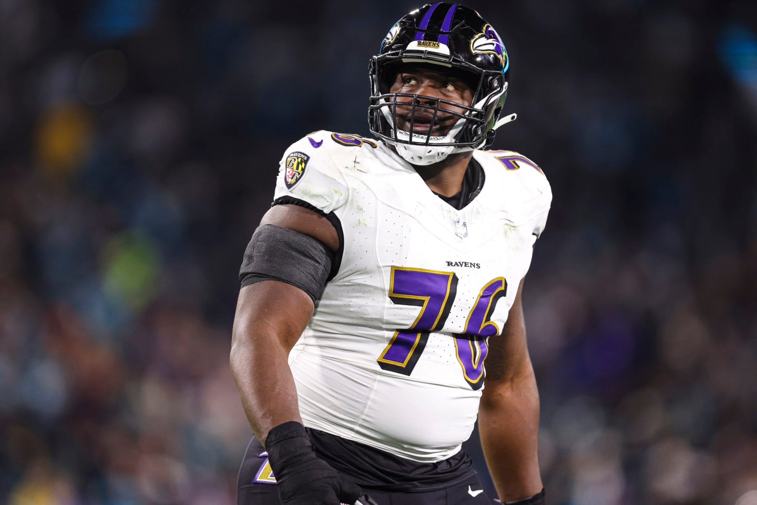 JACKSONVILLE, FL - DECEMBER 17: John Simpson #76 of the Baltimore Ravens looks on from the field during an NFL football game against the Jacksonville Jaguars at EverBank Stadium on December 17, 2023 in Jacksonville, Florida. (Photo by Perry Knotts/Getty Images)