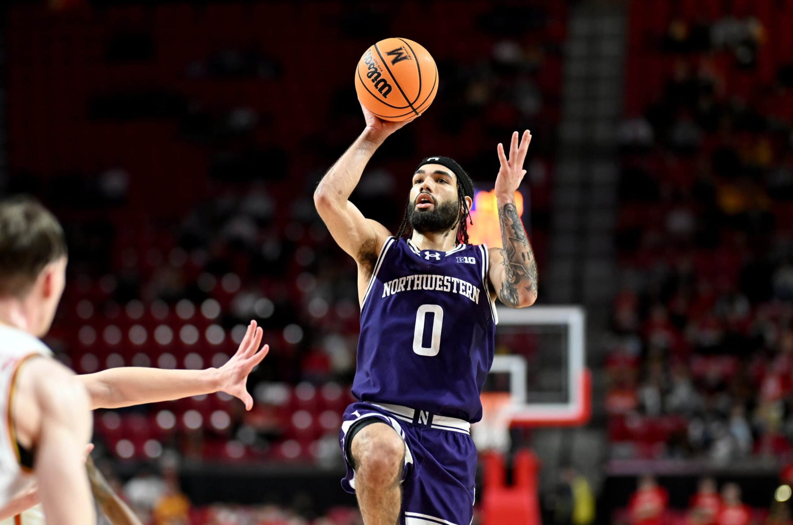 COLLEGE PARK, MARYLAND - FEBRUARY 28: Boo Buie #0 of the Northwestern Wildcats shoots the ball against the Maryland Terrapins at Xfinity Center on February 28, 2024 in College Park, Maryland. (Photo by G Fiume/Getty Images)