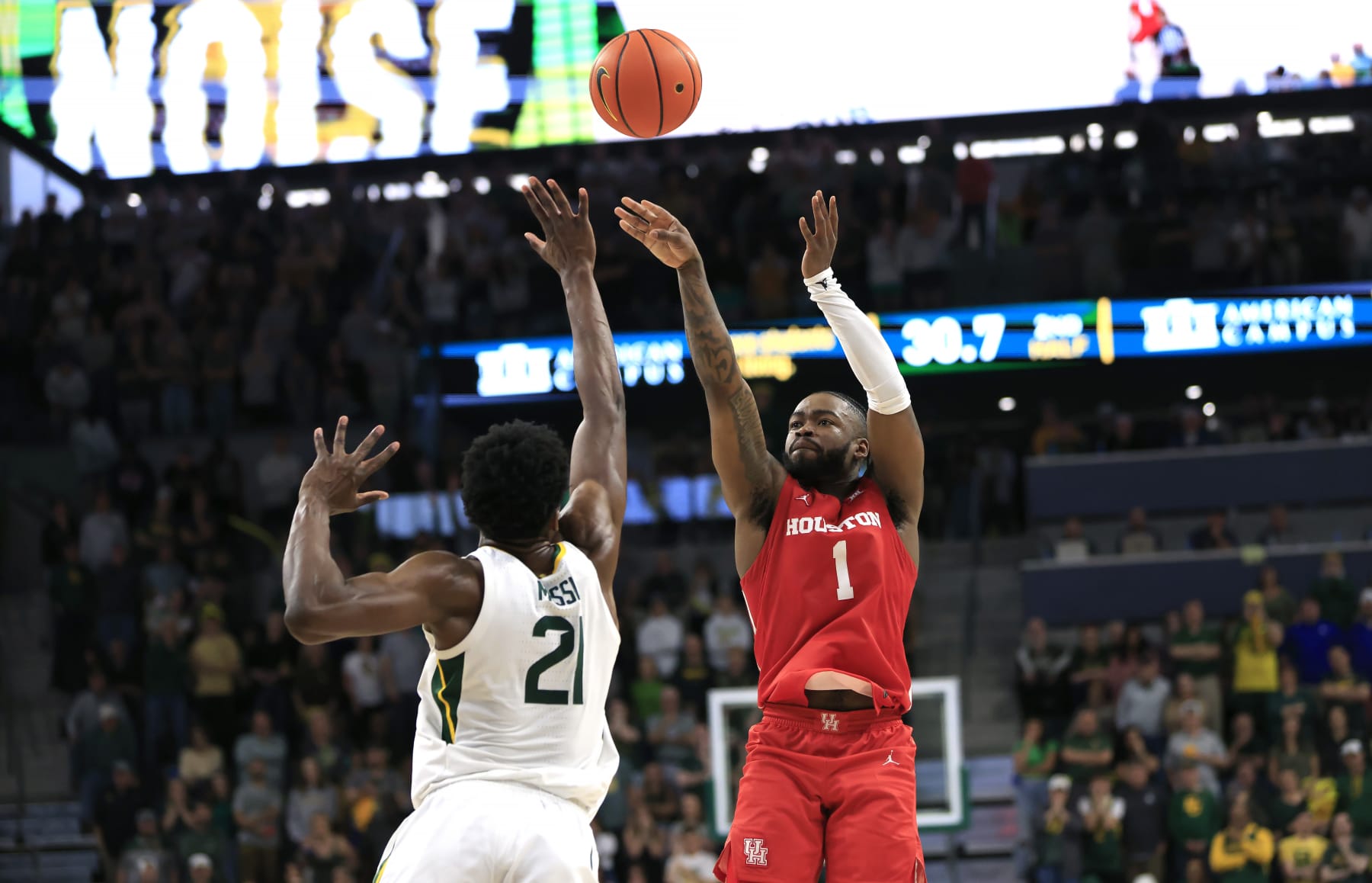WACO, TX - FEBRUARY 24: Jamal Shead #1 of the Houston Cougars attempts a shot over Yves Missi #21 of the Baylor Bears in the second half    at Foster Pavilion on February 24, 2024 in Waco, Texas. (Photo by Ron Jenkins/Getty Images)