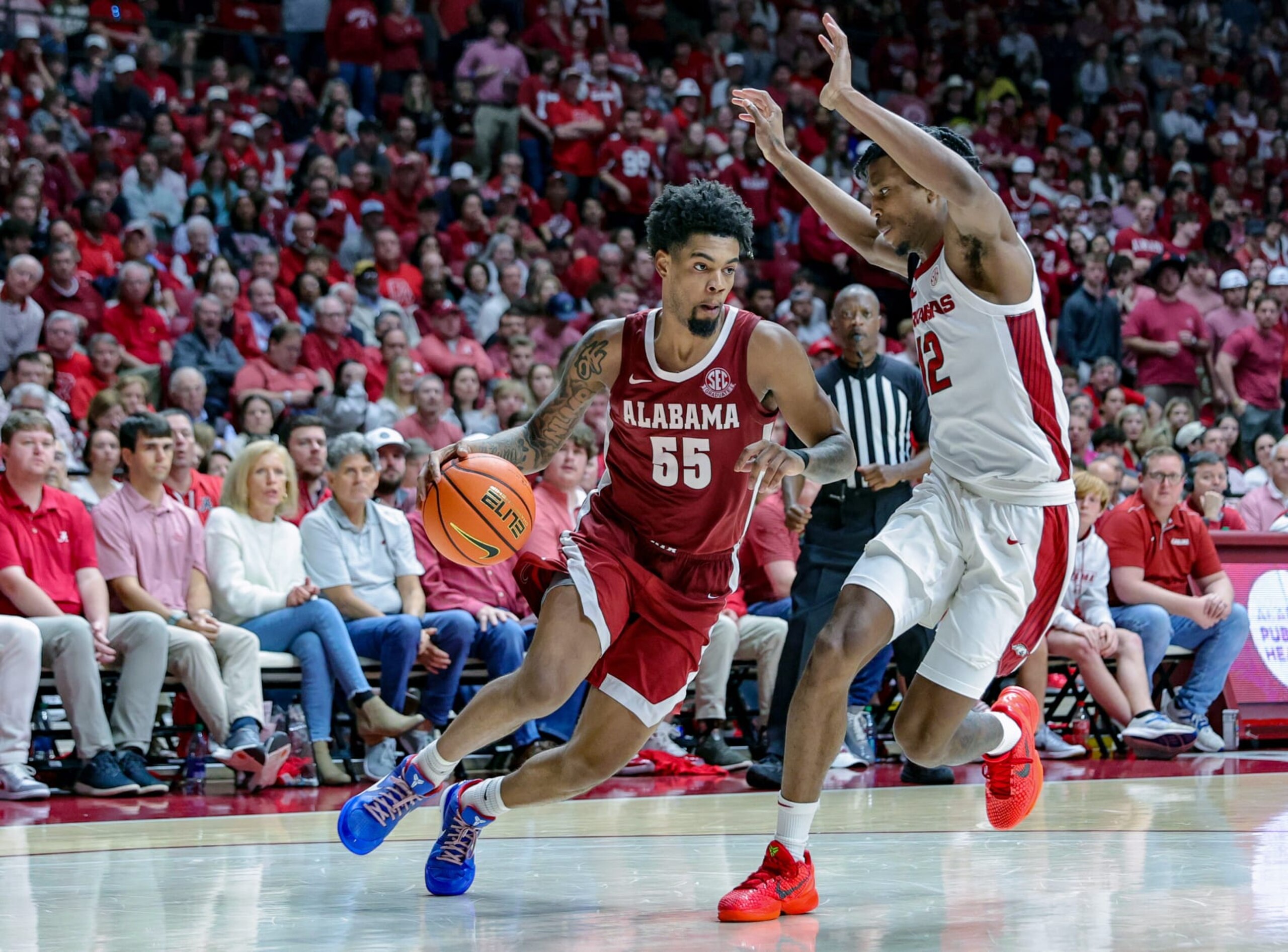 TUSCALOOSA, ALABAMA - MARCH 9: Aaron Estrada #55 of the Alabama Crimson Tide drives to the basket during the second half against Tramon Mark #12 of the Arkansas Razorbacks at Coleman Coliseum on March 9, 2024 in Tuscaloosa, Alabama. (Photo by Brandon Sumrall/Getty Images)