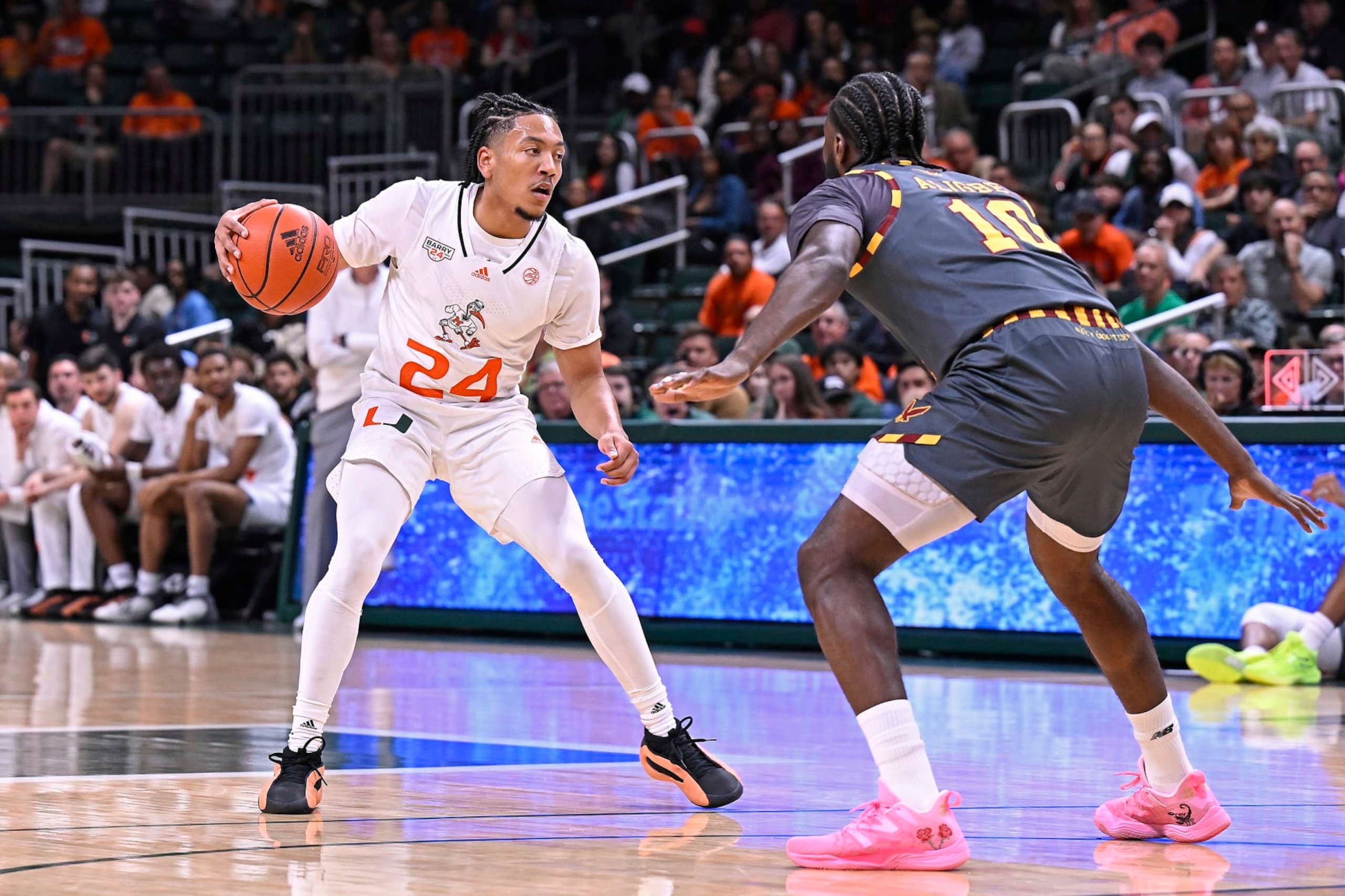 CORAL GABLES, FL - MARCH 06: Miami guard Nijel Pack (24) handles the ball while defended by Boston College guard/forward Prince Aligbe (10) in the first half as the Miami Hurricanes faced the Boston College Eagles on March 6, 2024, at the Watsco Center in Coral Gables, Florida. (Photo by Samuel Lewis/Icon Sportswire via Getty Images)