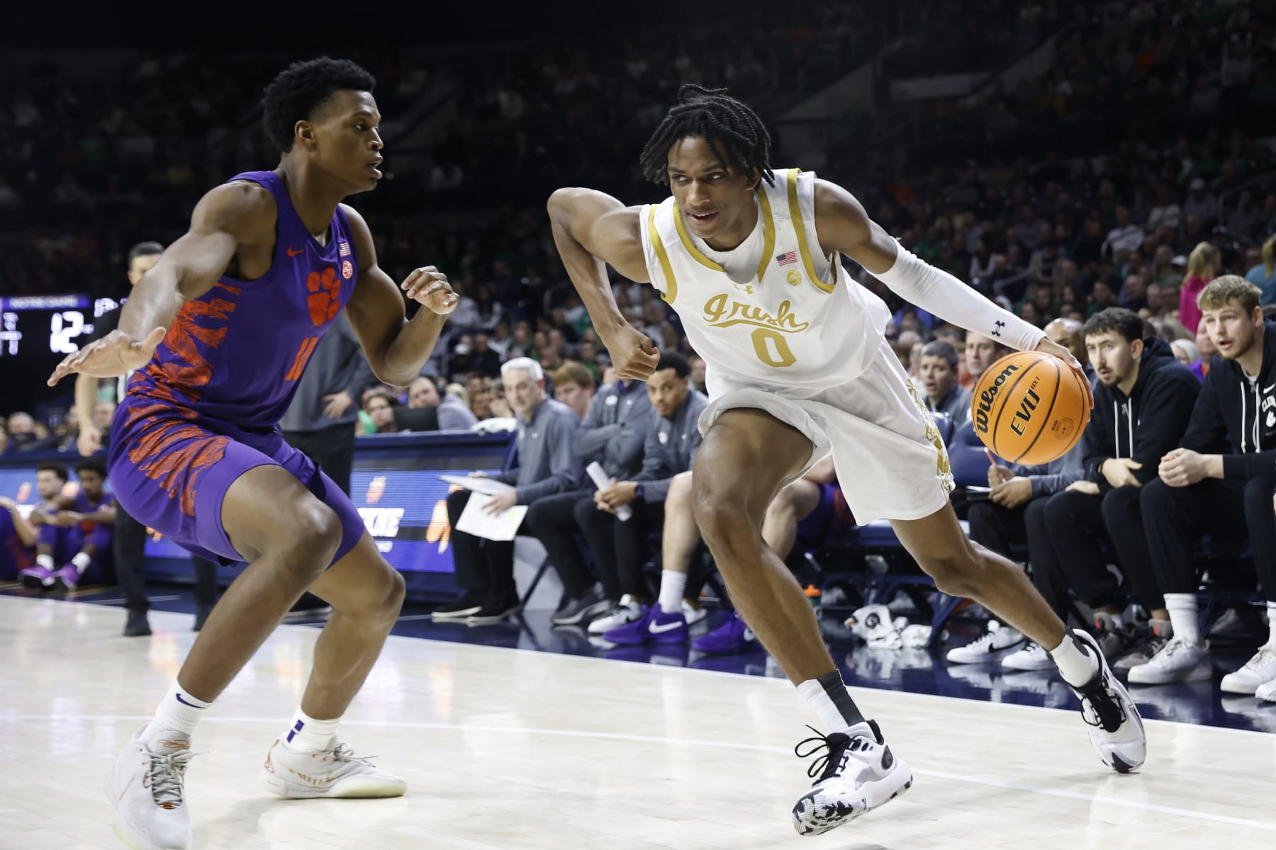 SOUTH BEND, INDIANA - MARCH 02: Carey Booth #0 of the Notre Dame Fighting Irish drives to the basket while defended by RJ Godfrey #10 of the Clemson Tigers at Joyce Center on March 02, 2024 in South Bend, Indiana. (Photo by Justin Casterline/Getty Images)