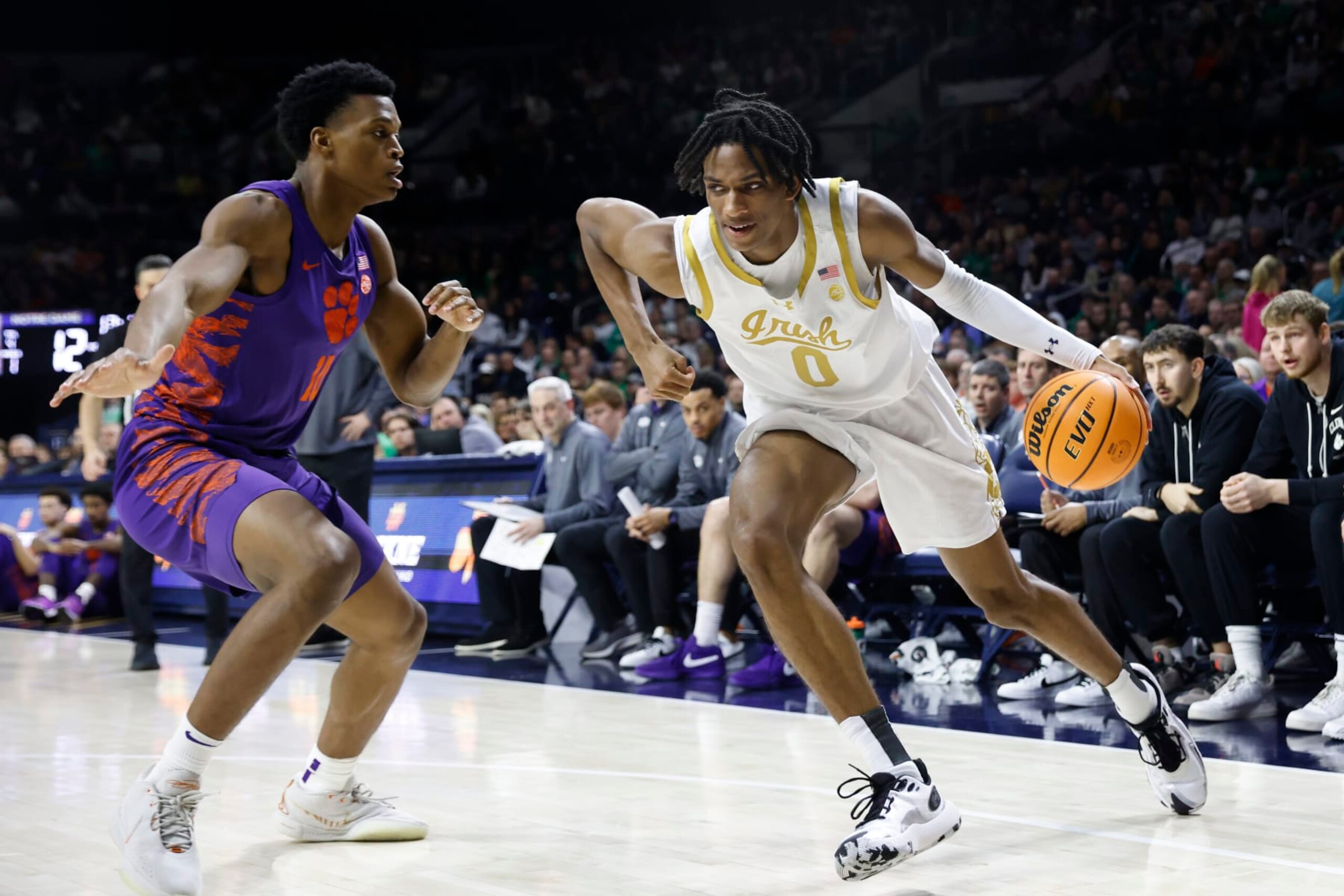 SOUTH BEND, INDIANA - MARCH 02: Carey Booth #0 of the Notre Dame Fighting Irish drives to the basket while defended by RJ Godfrey #10 of the Clemson Tigers at Joyce Center on March 02, 2024 in South Bend, Indiana. (Photo by Justin Casterline/Getty Images)