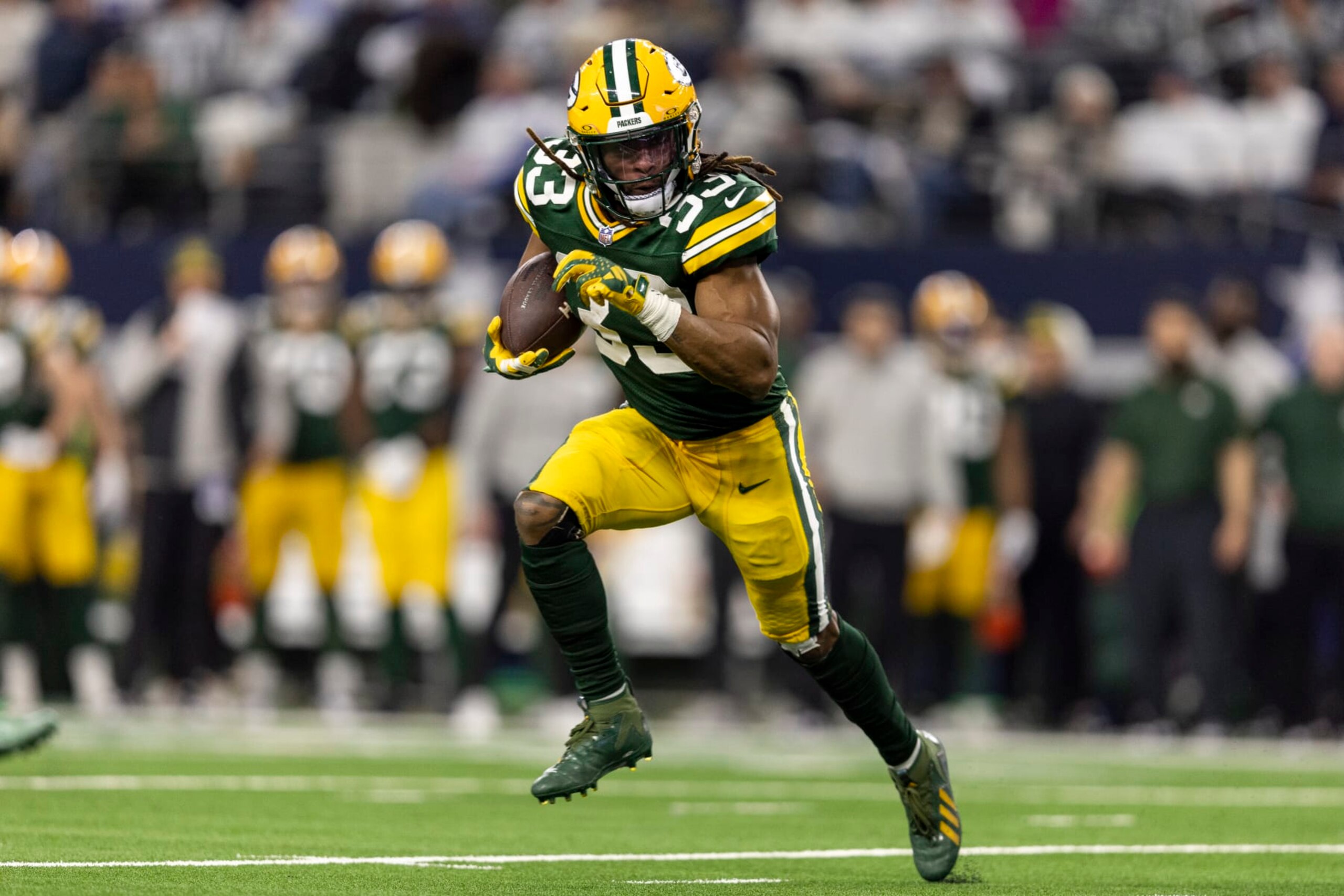 ARLINGTON, TEXAS - JANUARY 14: Aaron Jones #33 of the Green Bay Packers runs with the ball during an NFL wild-card playoff football game between the Dallas Cowboys and the Green Bay Packers at AT&T Stadium on January 14, 2024 in Arlington, Texas. (Photo by Michael Owens/Getty Images)