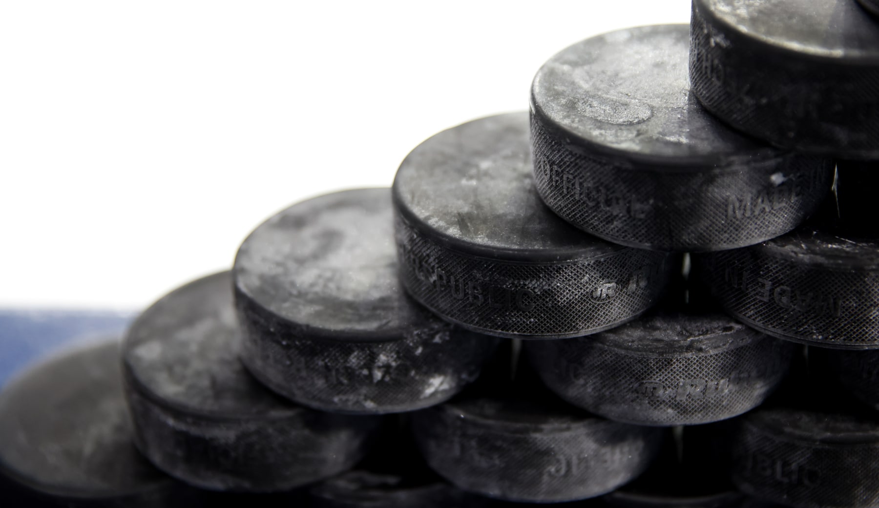 LOWELL, MASSACHUSETTS - NOVEMBER 4: A general view of a stack of pucks that sit on the dasher of the bench before a game between the UMass Lowell River Hawks and the Boston College Eagles during NCAA men's hockey at the Tsongas Center on November 4, 2023 in Lowell, Massachusetts. The Eagles won 3-2. (Photo by Richard T Gagnon/Getty Images)