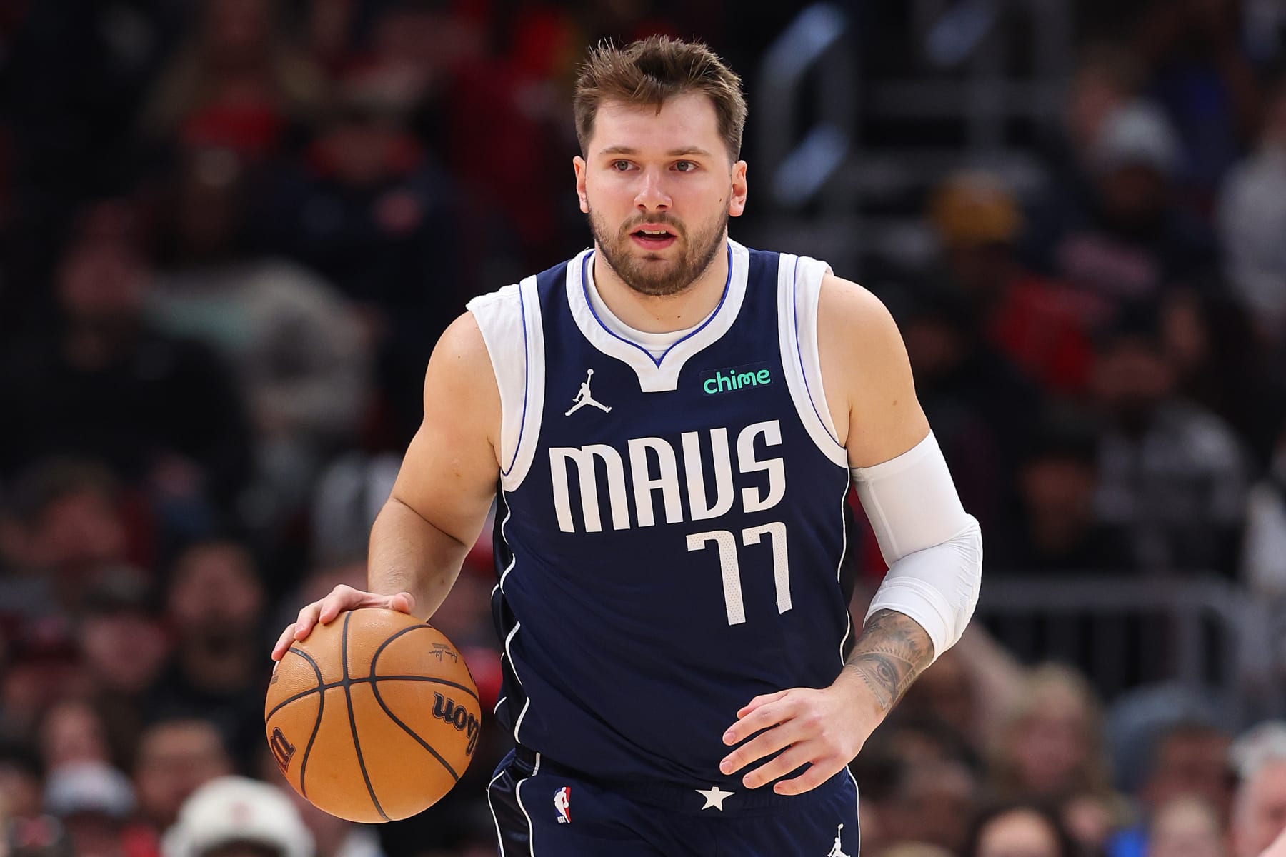 CHICAGO, ILLINOIS - MARCH 11: Luka Doncic #77 of the Dallas Mavericks dribbles up the court against the Chicago Bulls during the first half at the United Center on March 11, 2024 in Chicago, Illinois. NOTE TO USER: User expressly acknowledges and agrees that, by downloading and or using this photograph, User is consenting to the terms and conditions of the Getty Images License Agreement.  (Photo by Michael Reaves/Getty Images)