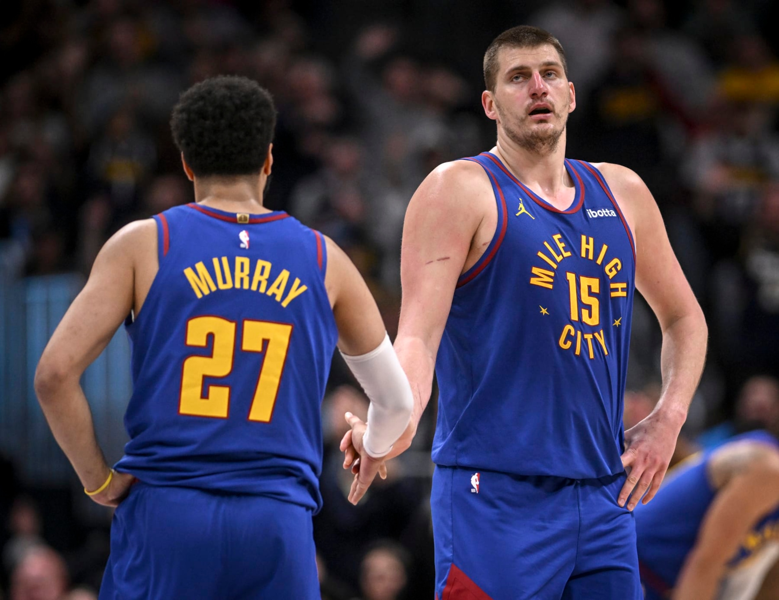 DENVER, CO - MARCH 5: Nikola Jokic (15) and Jamal Murray (27) of the Denver Nuggets shake hands during the fourth quarter of the Phoenix Suns' 117-107 win at Ball Arena in Denver on Tuesday, March 5, 2024. (Photo by AAron Ontiveroz/The Denver Post)