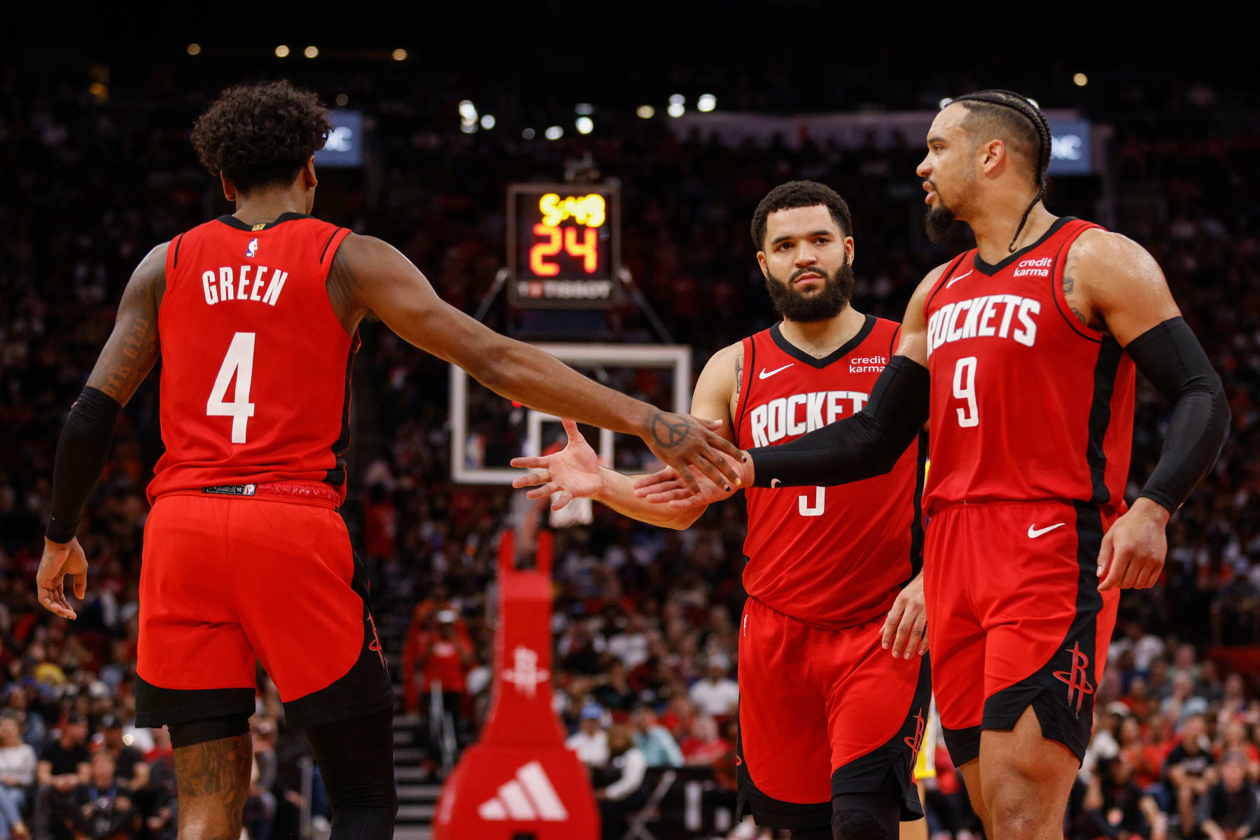 HOUSTON, TEXAS - OCTOBER 29: Jalen Green #4 of the Houston Rockets is congratulated by Dillon Brooks #9 and Fred VanVleet #5 in the second half against the Golden State Warriors at Toyota Center on October 29, 2023 in Houston, Texas.  NOTE TO USER: User expressly acknowledges and agrees that, by downloading and or using this photograph, User is consenting to the terms and conditions of the Getty Images License Agreement. (Photo by Tim Warner/Getty Images)