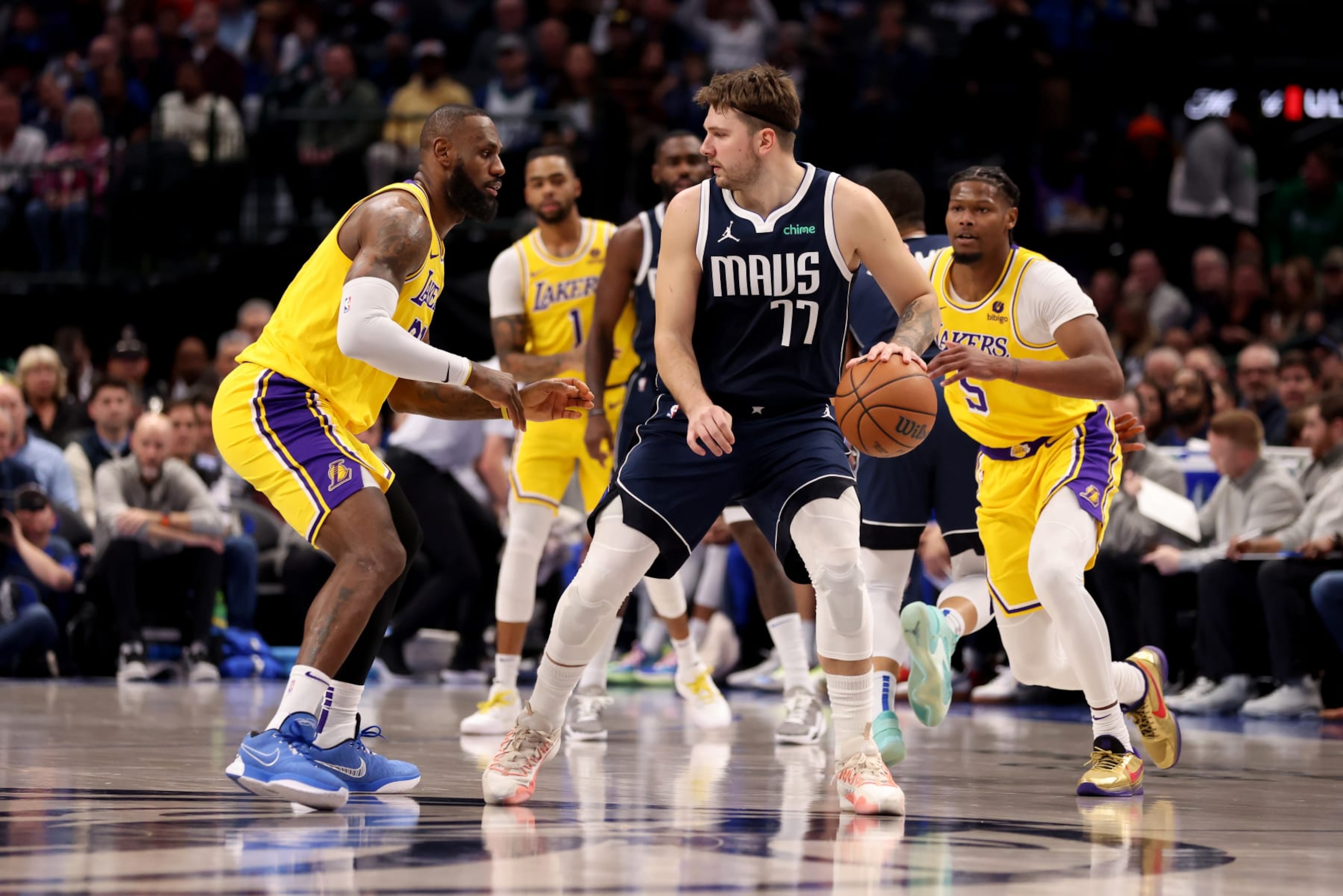 DALLAS, TEXAS - DECEMBER 12: Luka Doncic #77 of the Dallas Mavericks dribbles the ball while guarded by LeBron James #23 of the Los Angeles Lakers in the first half at American Airlines Center on December 12, 2023 in Dallas, Texas. NOTE TO USER: User expressly acknowledges and agrees that, by downloading and or using this photograph, User is consenting to the terms and conditions of the Getty Images License Agreement. (Photo by Tim Heitman/Getty Images) DALLAS, TEXAS - DECEMBER 12: Luka Doncic #77 of the Dallas Mavericks dribbles the ball while guarded by LeBron James #23 of the Los Angeles Lakers in the first half at American Airlines Center on December 12, 2023 in Dallas, Texas. NOTE TO USER: User expressly acknowledges and agrees that, by downloading and or using this photograph, User is consenting to the terms and conditions of the Getty Images License Agreement. (Photo by Tim Heitman/Getty Images)