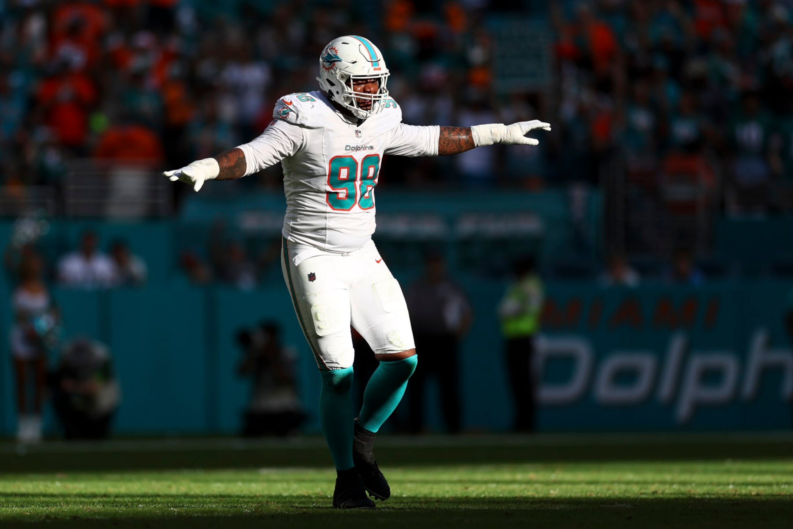 MIAMI GARDENS, FL - DECEMBER 17: Raekwon Davis #98 of the Miami Dolphins celebrates after a play during the fourth quarter of an NFL football game against the New York Jets at Hard Rock Stadium on December 17, 2023 in Miami Gardens, Florida. (Photo by Kevin Sabitus/Getty Images)