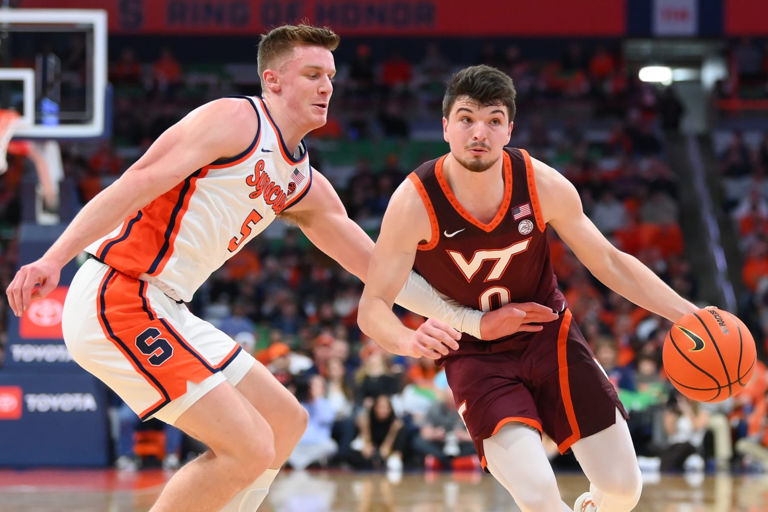 SYRACUSE, NEW YORK - FEBRUARY 27: Hunter Cattoor #0 of the Virginia Tech Hokies drives against Justin Taylor #5 of the Syracuse Orange during the first half at the JMA Wireless Dome on February 27, 2024 in Syracuse, New York. Syracuse won 84-71. (Photo by Rich Barnes/Getty Images)