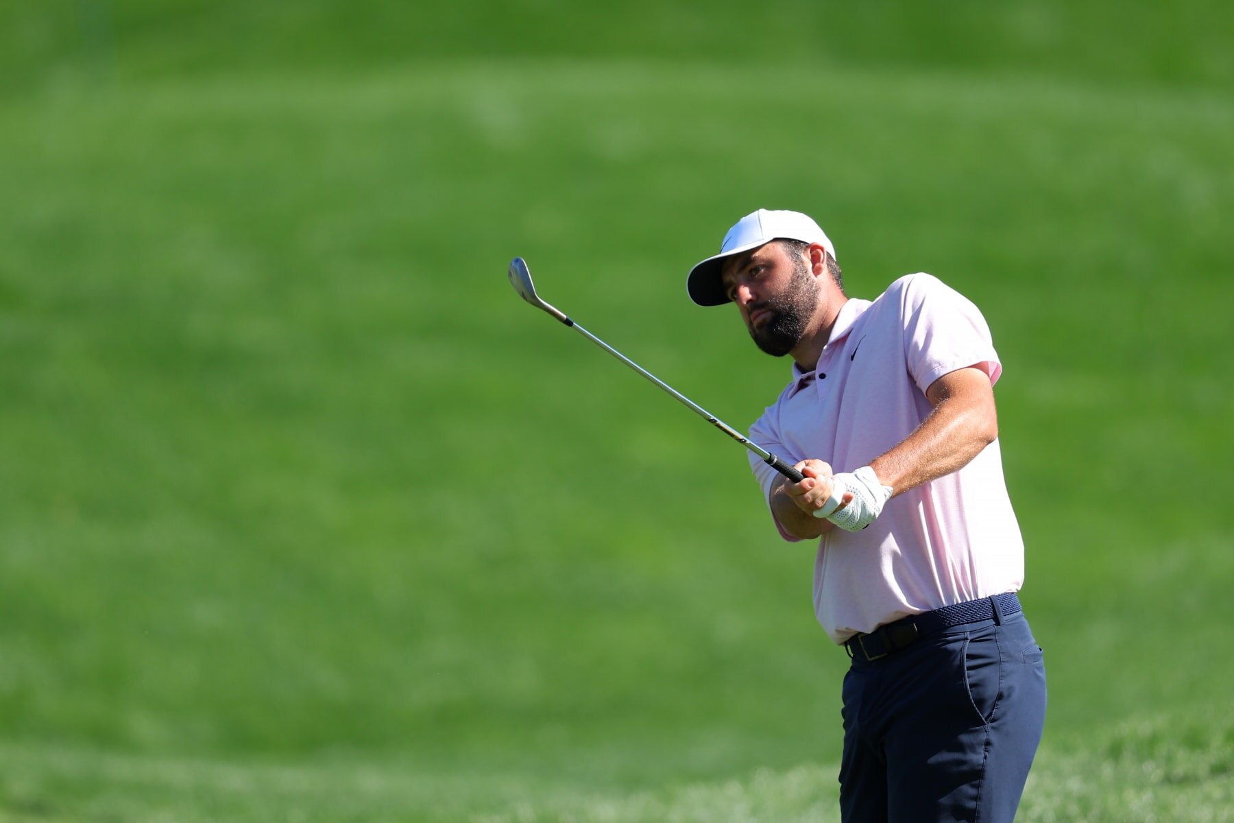 PONTE VEDRA BEACH, FLORIDA - MARCH 12:  Scottie Scheffler of the United States chips on the 11th green during a practice round prior to THE PLAYERS Championship on the Stadium Course at TPC Sawgrass on March 12, 2024 in Ponte Vedra Beach, Florida. (Photo by Kevin C. Cox/Getty Images)
