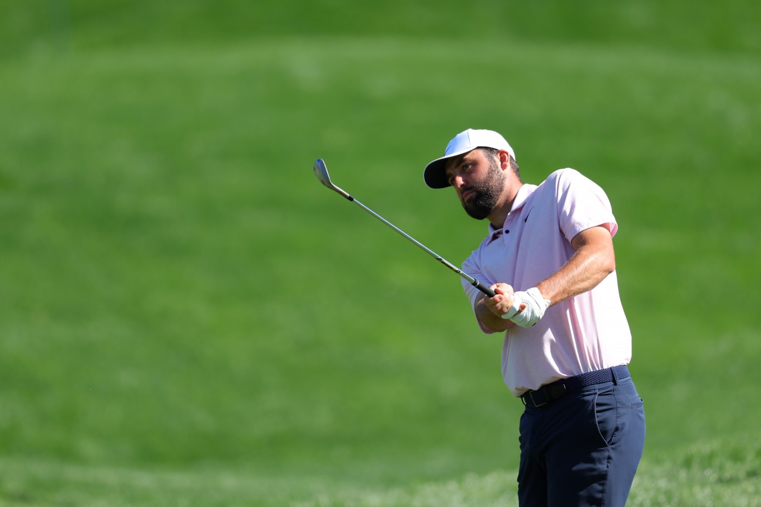 PONTE VEDRA BEACH, FLORIDA - MARCH 12:  Scottie Scheffler of the United States chips on the 11th green during a practice round prior to THE PLAYERS Championship on the Stadium Course at TPC Sawgrass on March 12, 2024 in Ponte Vedra Beach, Florida. (Photo by Kevin C. Cox/Getty Images)